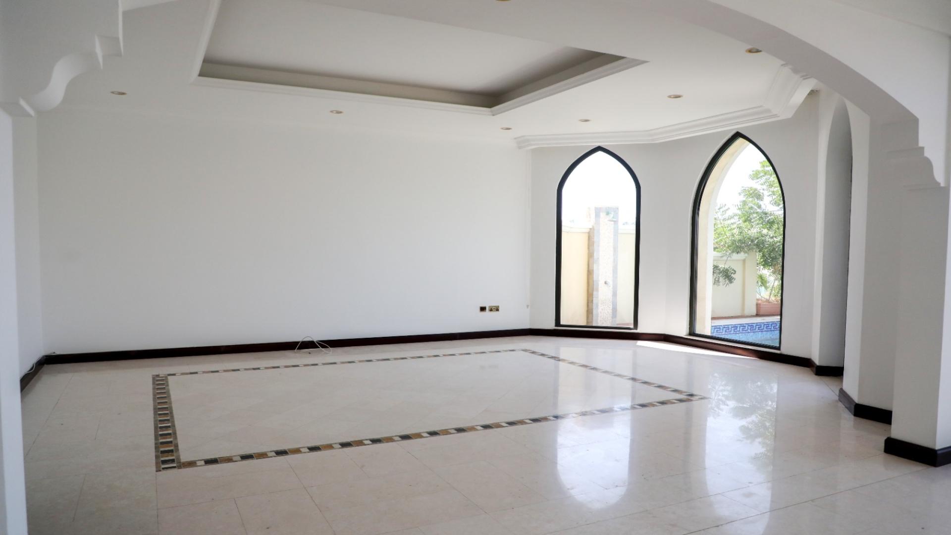 Luxurious villa with private beach access on Palm Jumeirah, surrounded by lush greenery