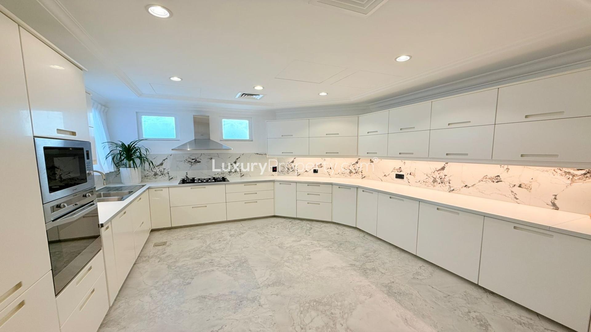 Luxurious living room in Palm Jumeirah villa with elegant chandelier and waterfront view