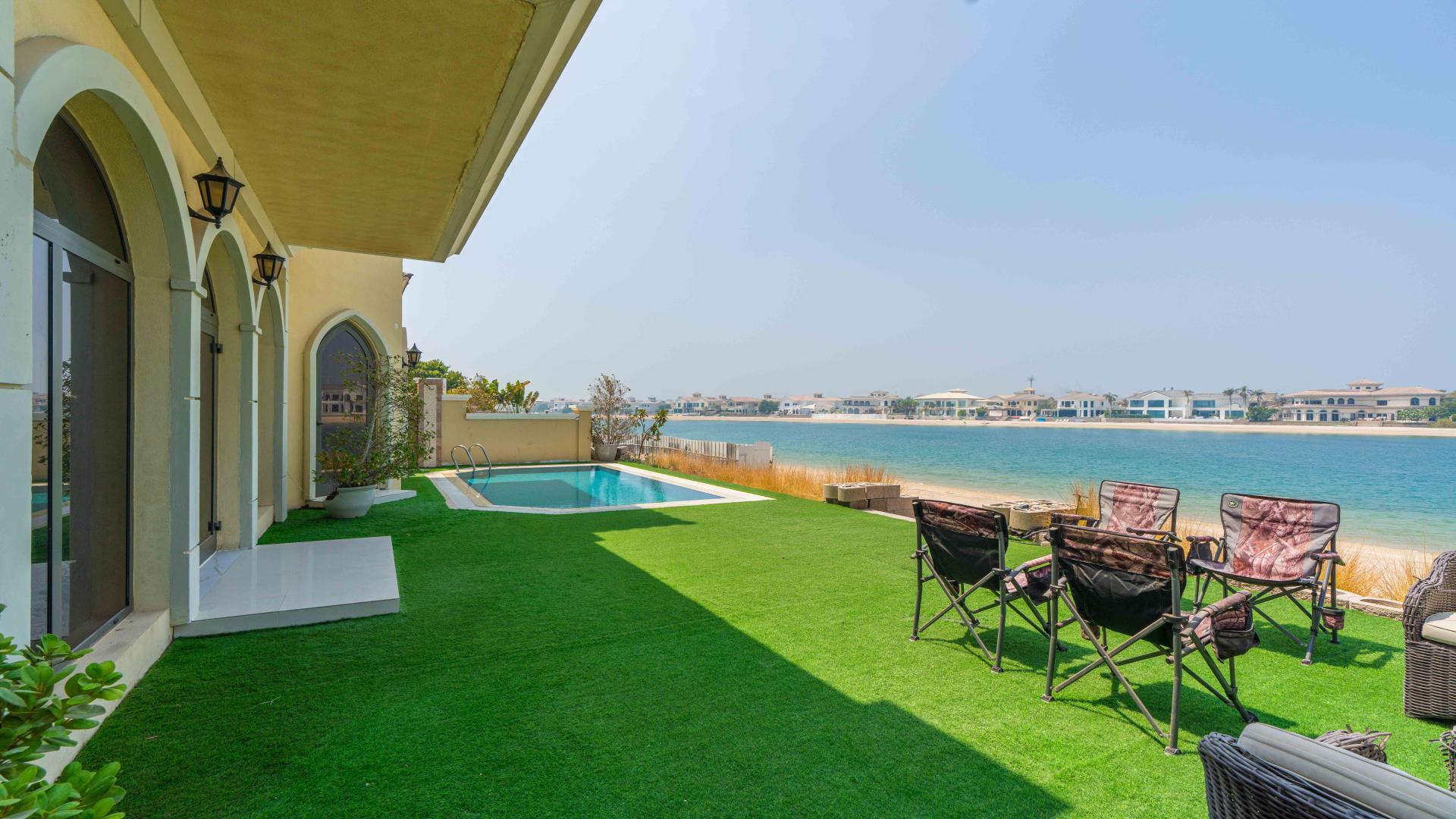 Dining area with marble table and pool view in Palm Jumeirah villa