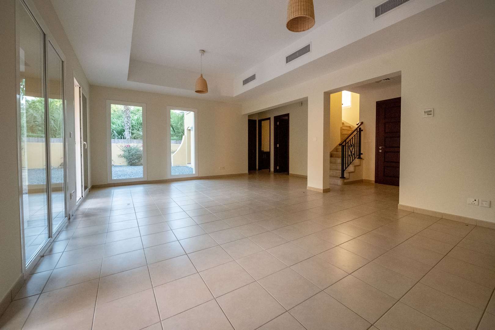 Empty room with tiled floor and two windows in Palmera 4 villa, Arabian Ranches