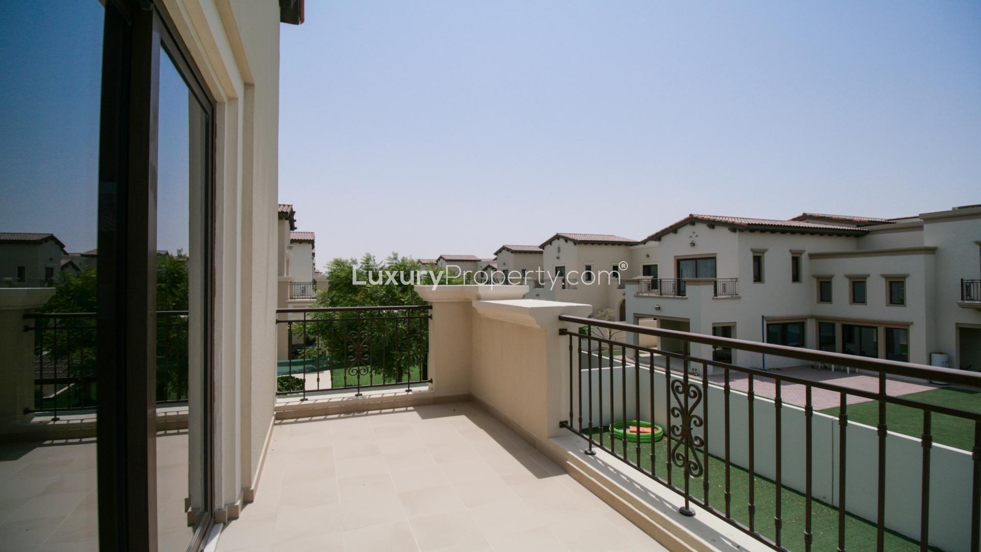 Spacious living room in Arabian Ranches 2 villa with large windows and garden view