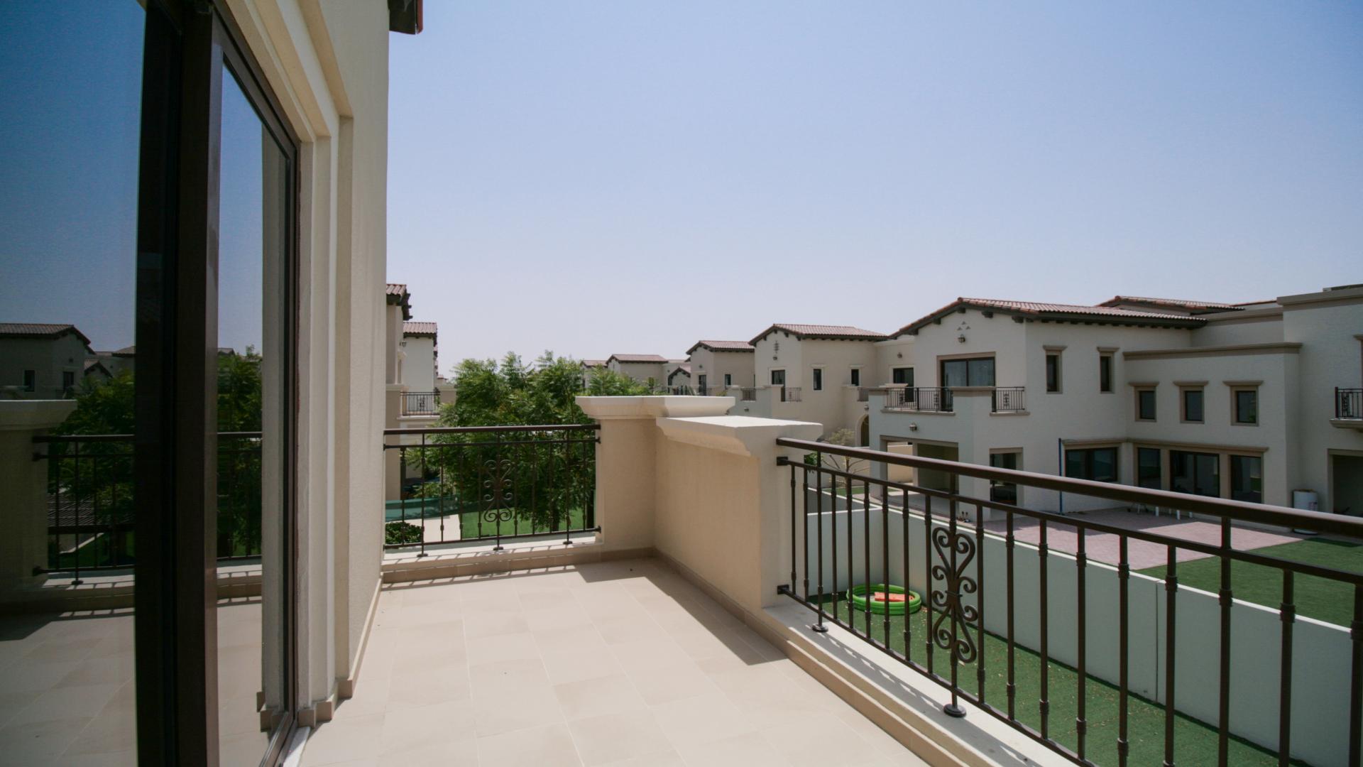 Spacious living room in Arabian Ranches 2 villa with large windows and garden view