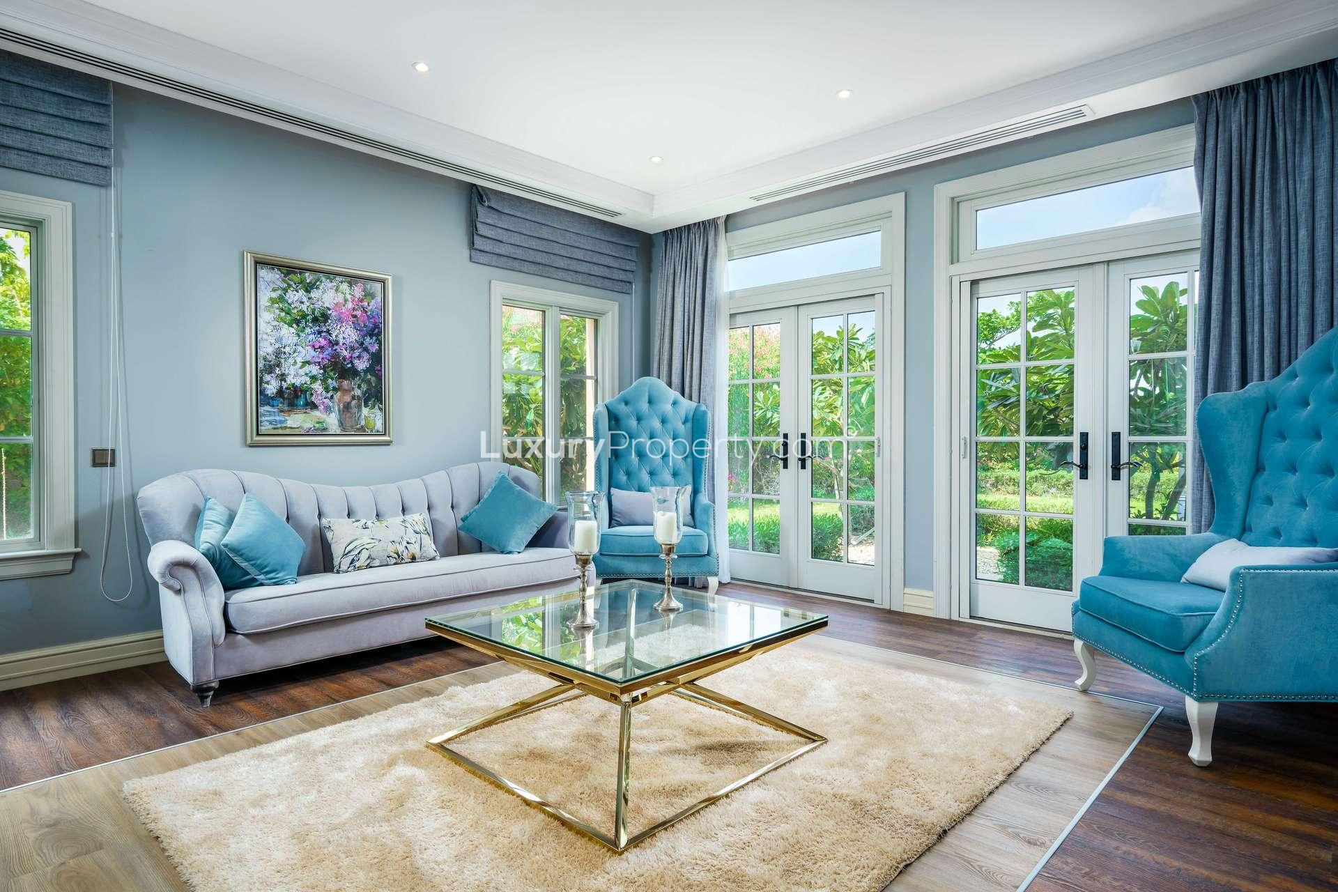 Spacious kitchen with island and open plan living area in Jumeirah Golf Estates villa