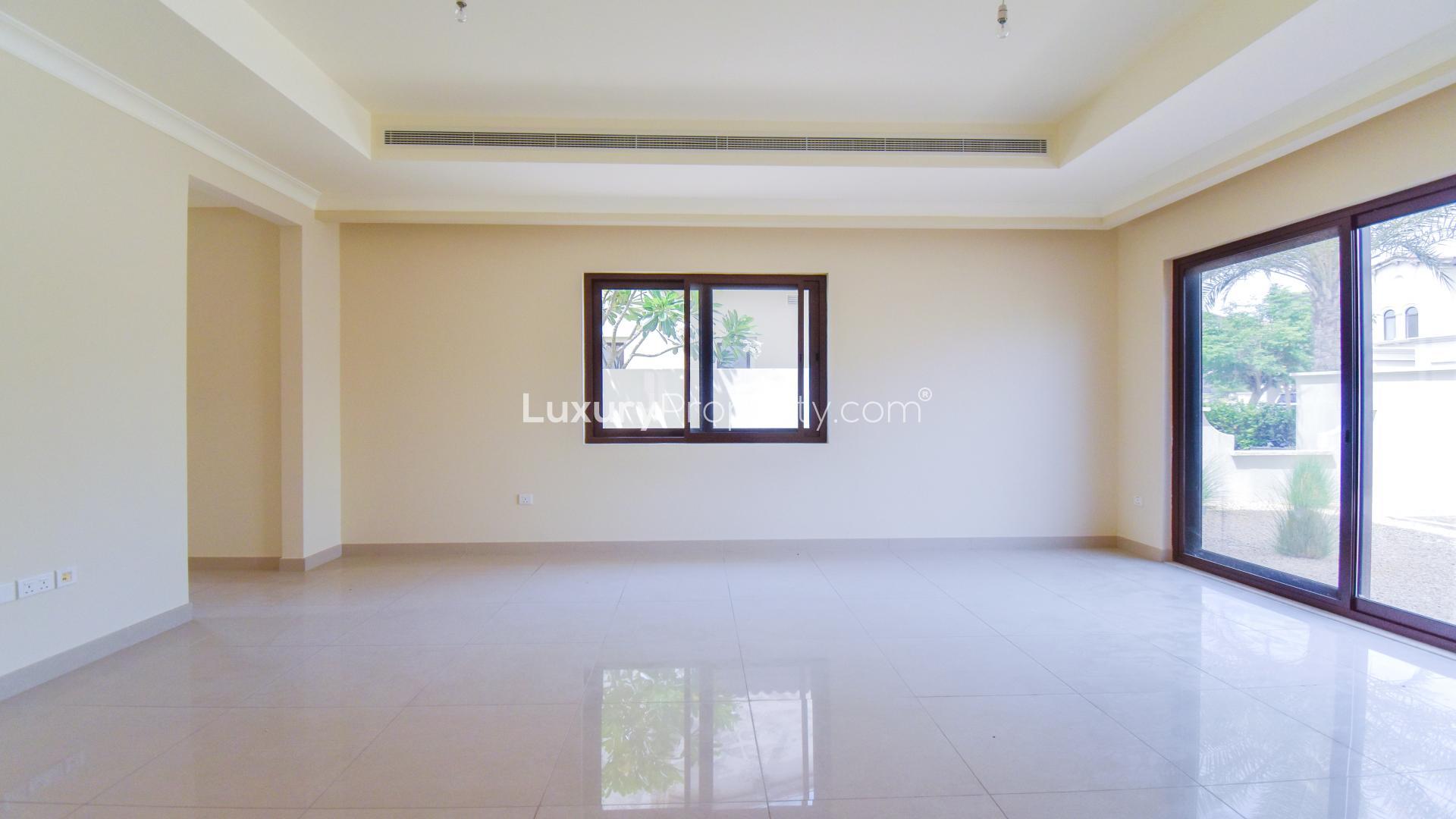 Spacious living room in 4-bedroom villa, Rosa, Arabian Ranches 2, with large windows and garden view