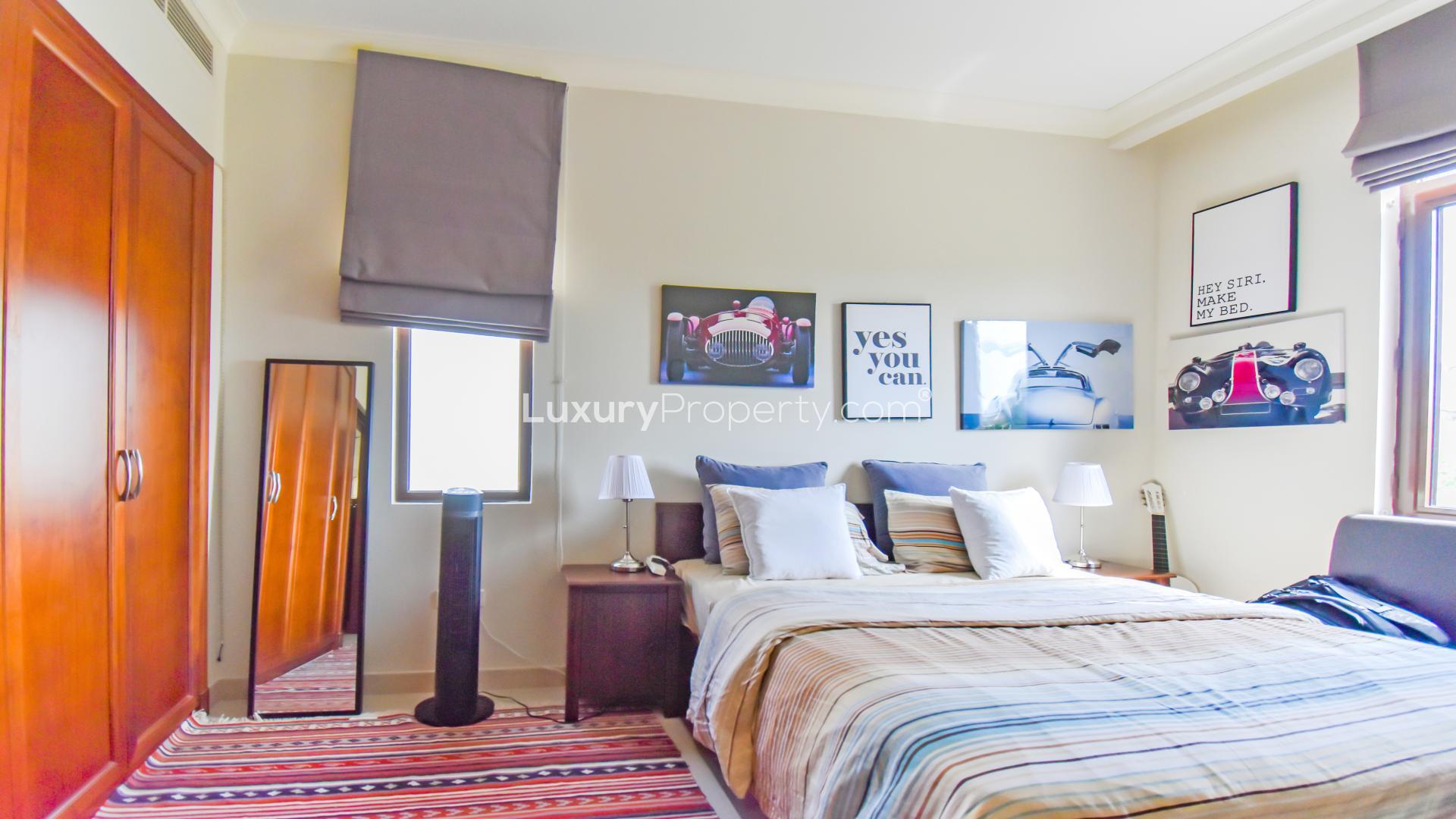 Modern bedroom in 4-bedroom Rosa villa, Arabian Ranches 2, featuring stylish decor and workspace