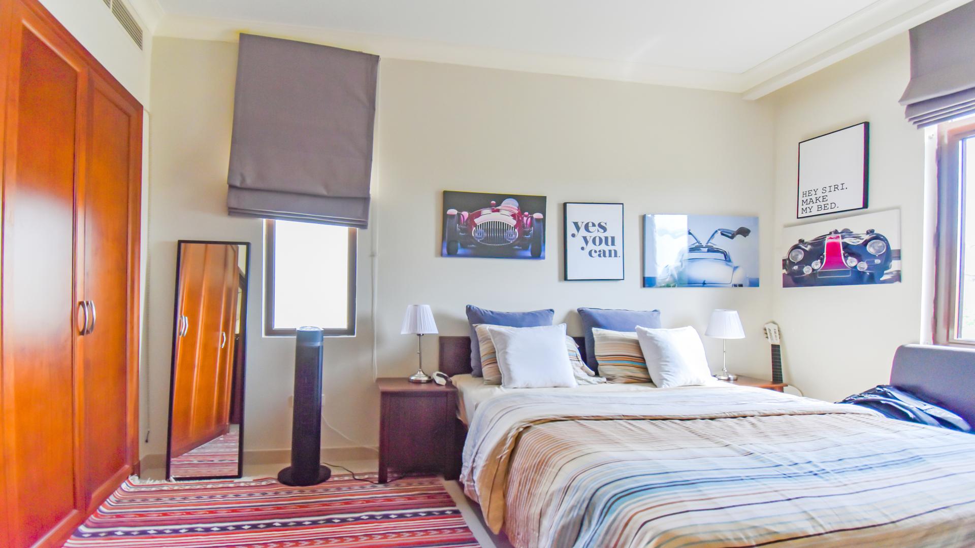 Modern bedroom in 4-bedroom Rosa villa, Arabian Ranches 2, featuring stylish decor and workspace