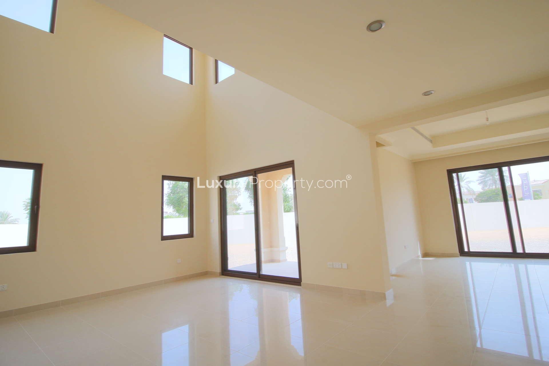 "Spacious 4-bedroom villa exterior with garden in Rosa, Arabian Ranches 2 for rent.","Bright living room in 4-bedroom villa, Rosa, Arabian Ranches 2, available for rent.",Spacious living area in 4-bedroom villa for rent, Rosa, Arabian Ranches 2