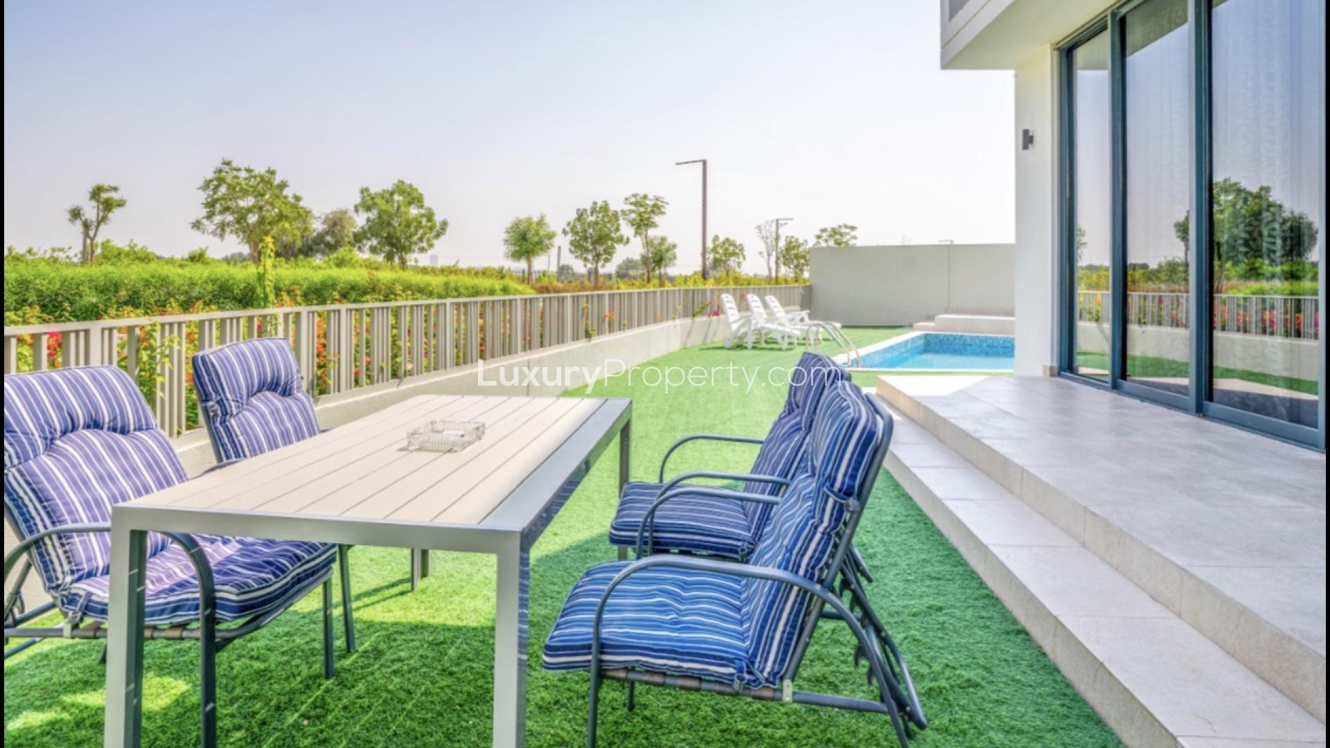 Modern living room in Golf Grove villa, Dubai Hills Estate, featuring stylish decor and ample seating