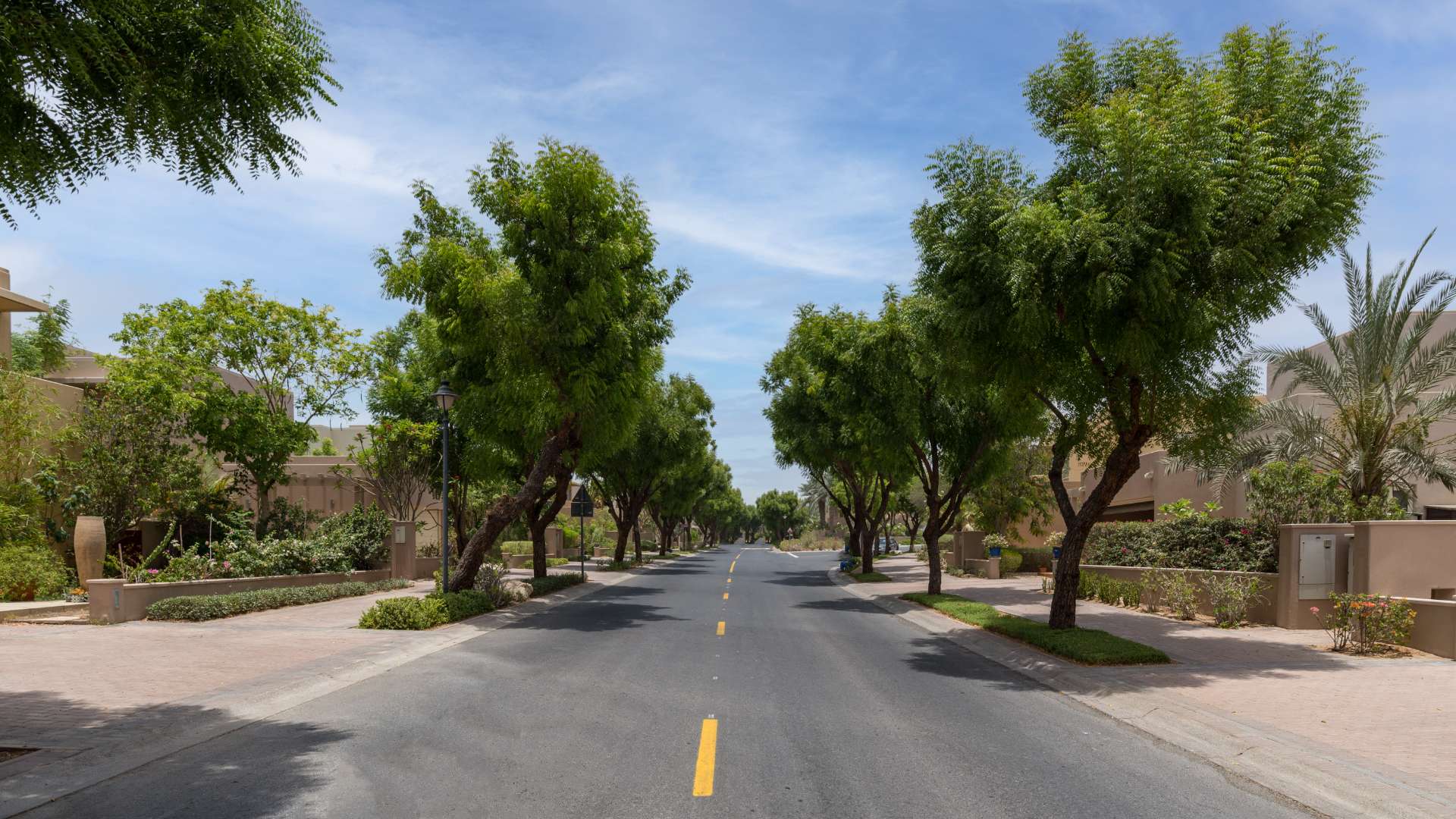 Pathway through lush park near fully furnished villa in Arabian Ranches, Saheel