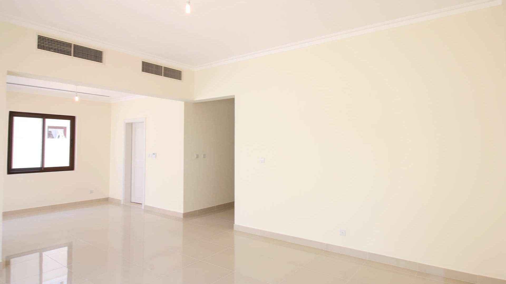 "Spacious living room in Samara villa, Arabian Ranches 2, with large windows and tiled floors.",Empty living room in modern Samara villa, Arabian Ranches 2, with tiled flooring