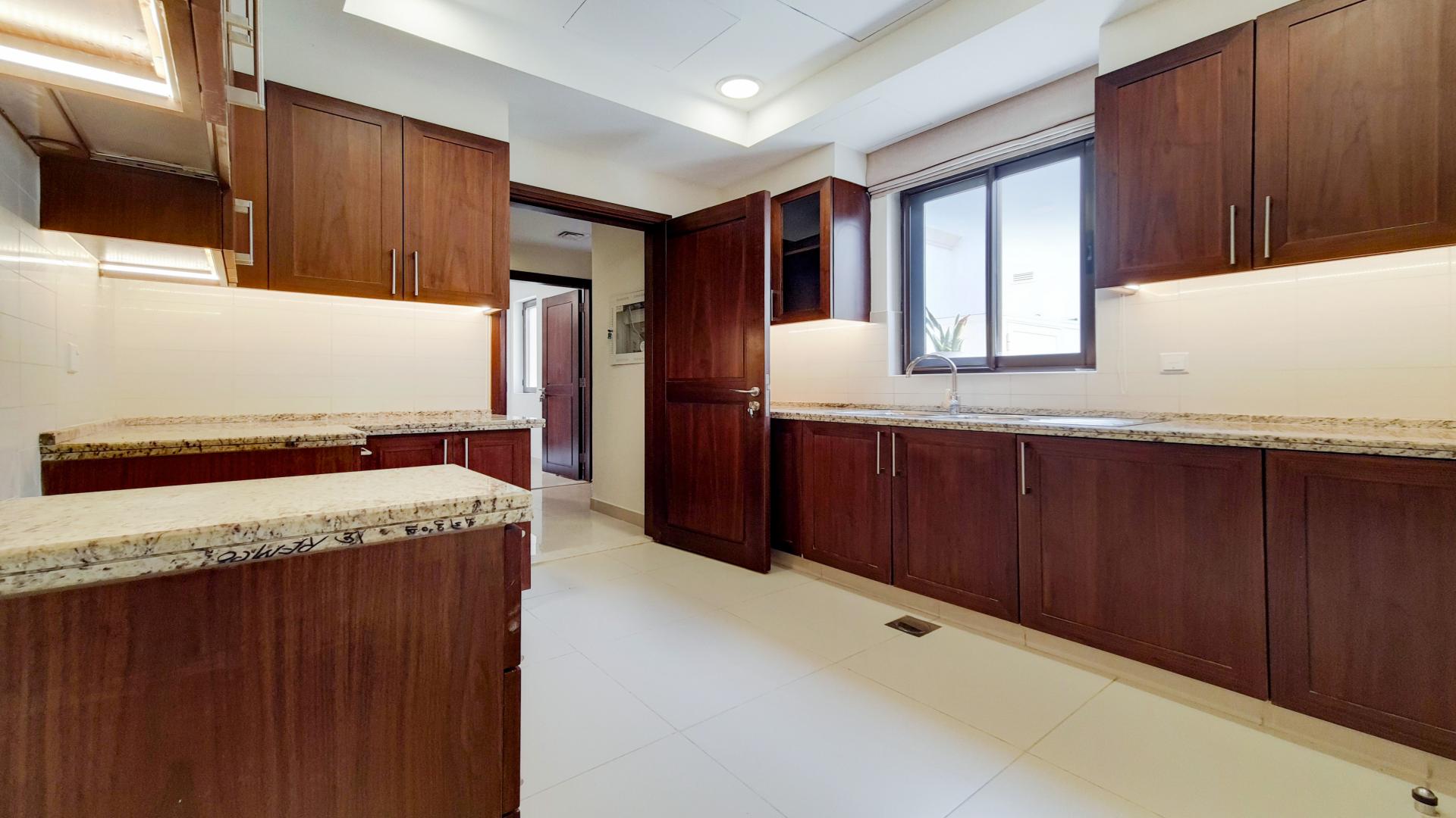 Spacious kitchen with wooden cabinets in four-bed villa, Arabian Ranches 2, Samara