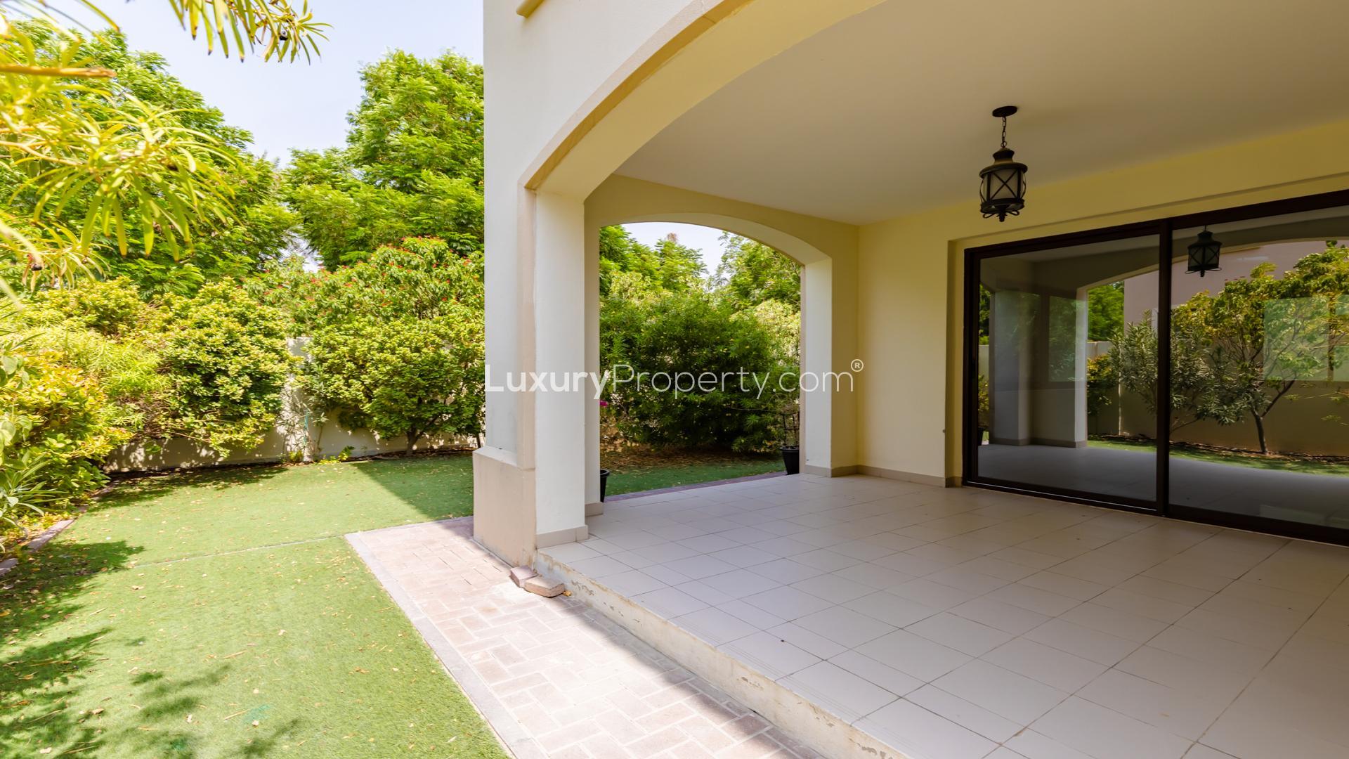 "Spacious living room in 5-bedroom villa, Samara, Arabian Ranches 2, available for rent.",Covered patio and lush garden view at Samara villa, Arabian Ranches 2