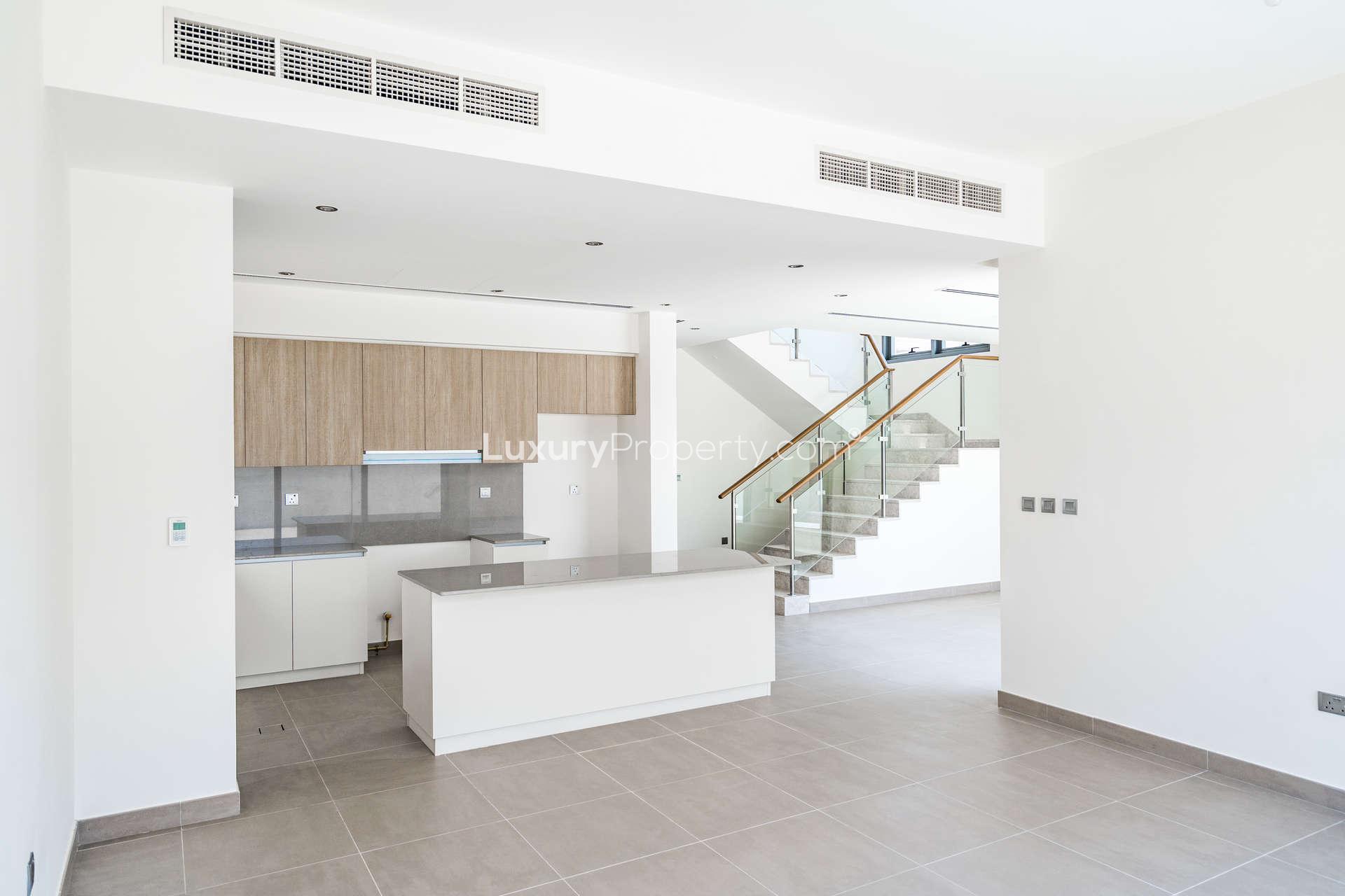 Modern kitchen and staircase in 4-bedroom villa, Sidra Villas, Dubai Hills Estate