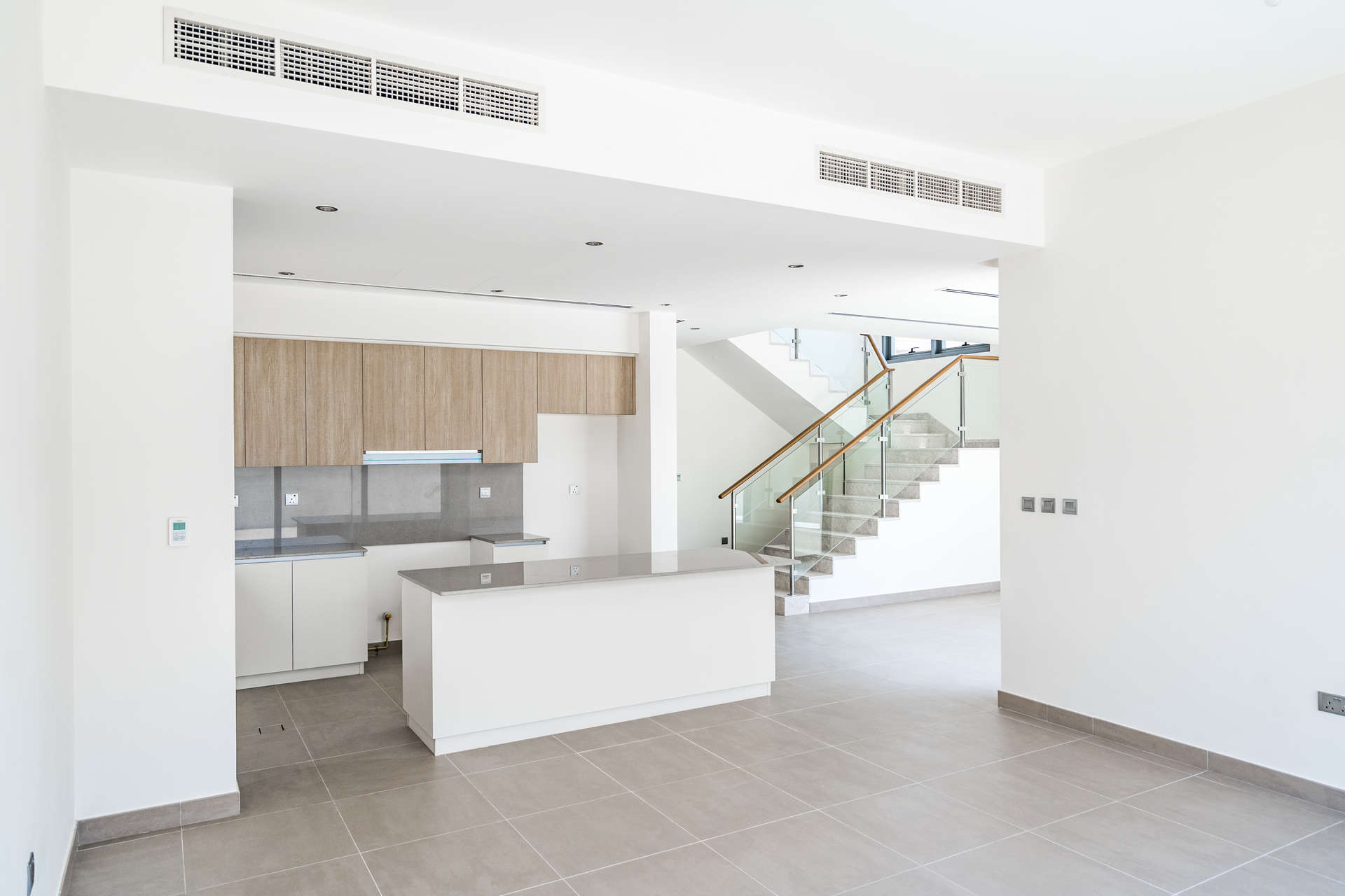 Modern kitchen and staircase in 4-bedroom villa, Sidra Villas, Dubai Hills Estate