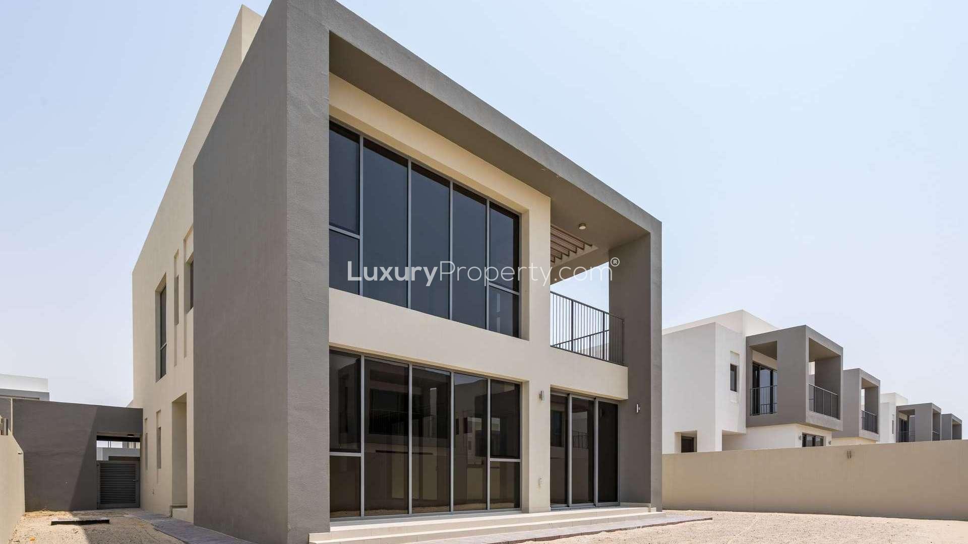Modern villa entrance with glass doors in Dubai Hills' Sidra community, available for rent