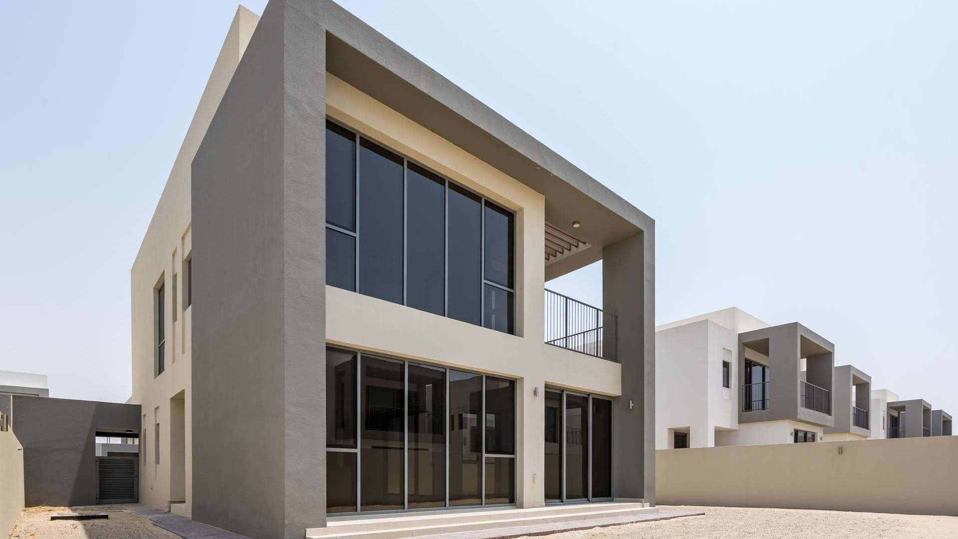 Modern villa entrance with glass doors in Dubai Hills' Sidra community, available for rent