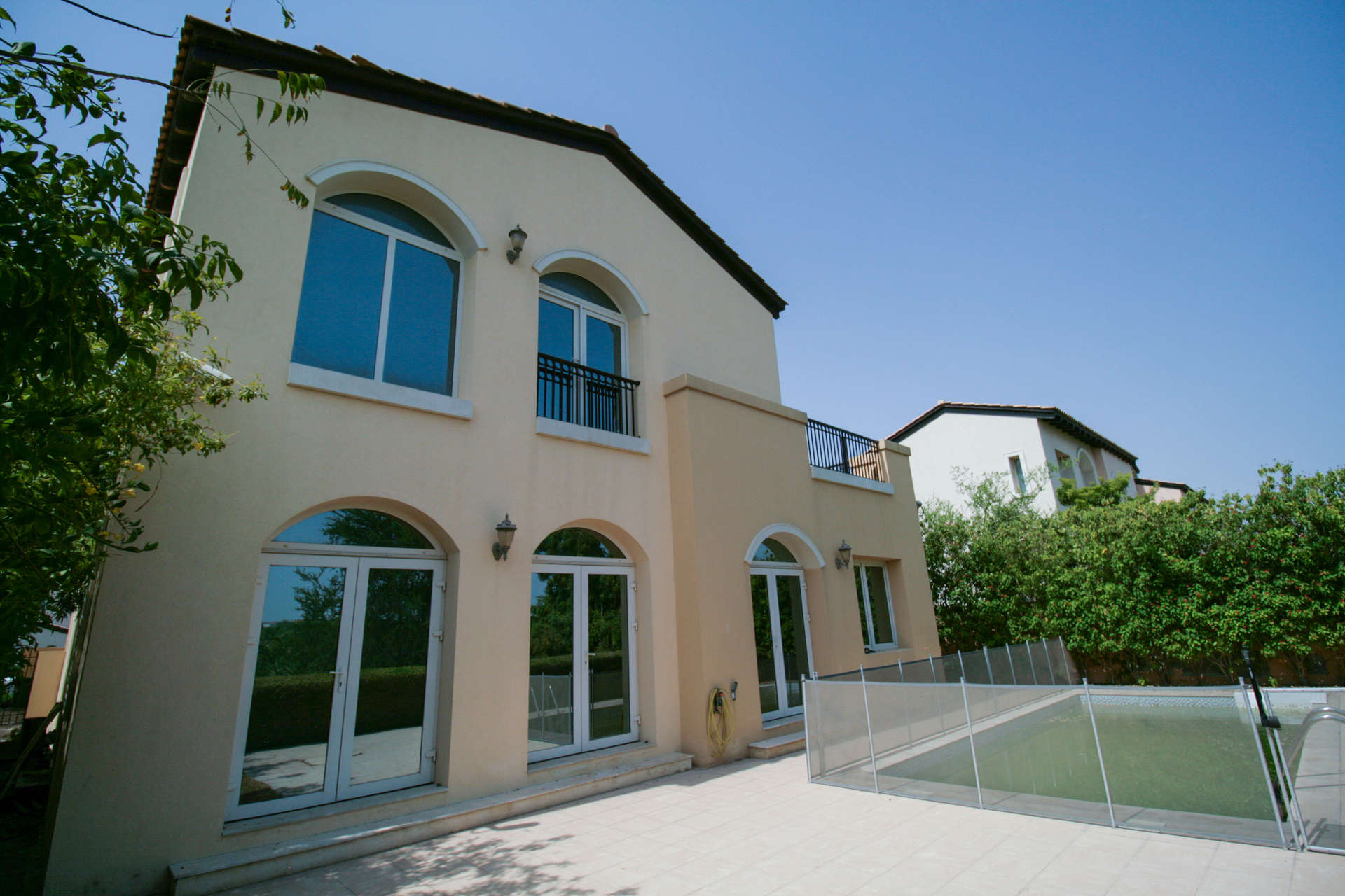 Bright villa interior with large windows, overlooking garden in Jumeirah Golf Estates Fire community