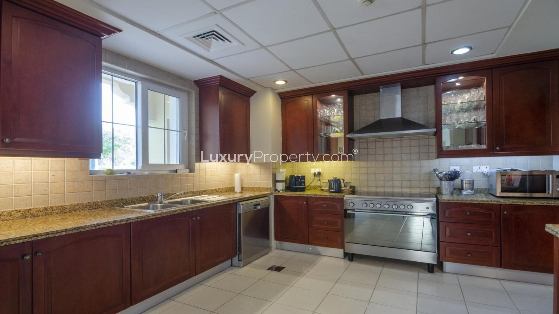 Front entrance of Mirador La Coleccion villa with garden in Arabian Ranches