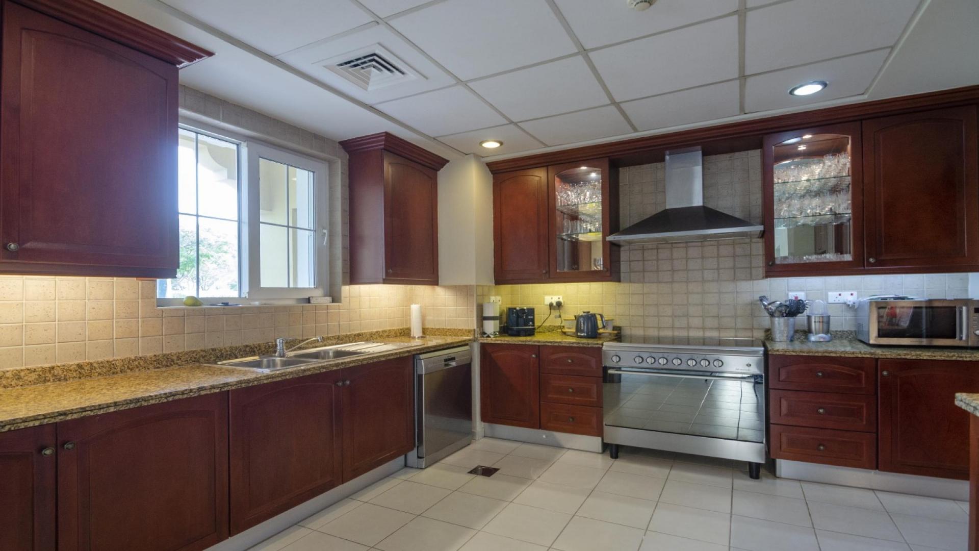 Front entrance of Mirador La Coleccion villa with garden in Arabian Ranches