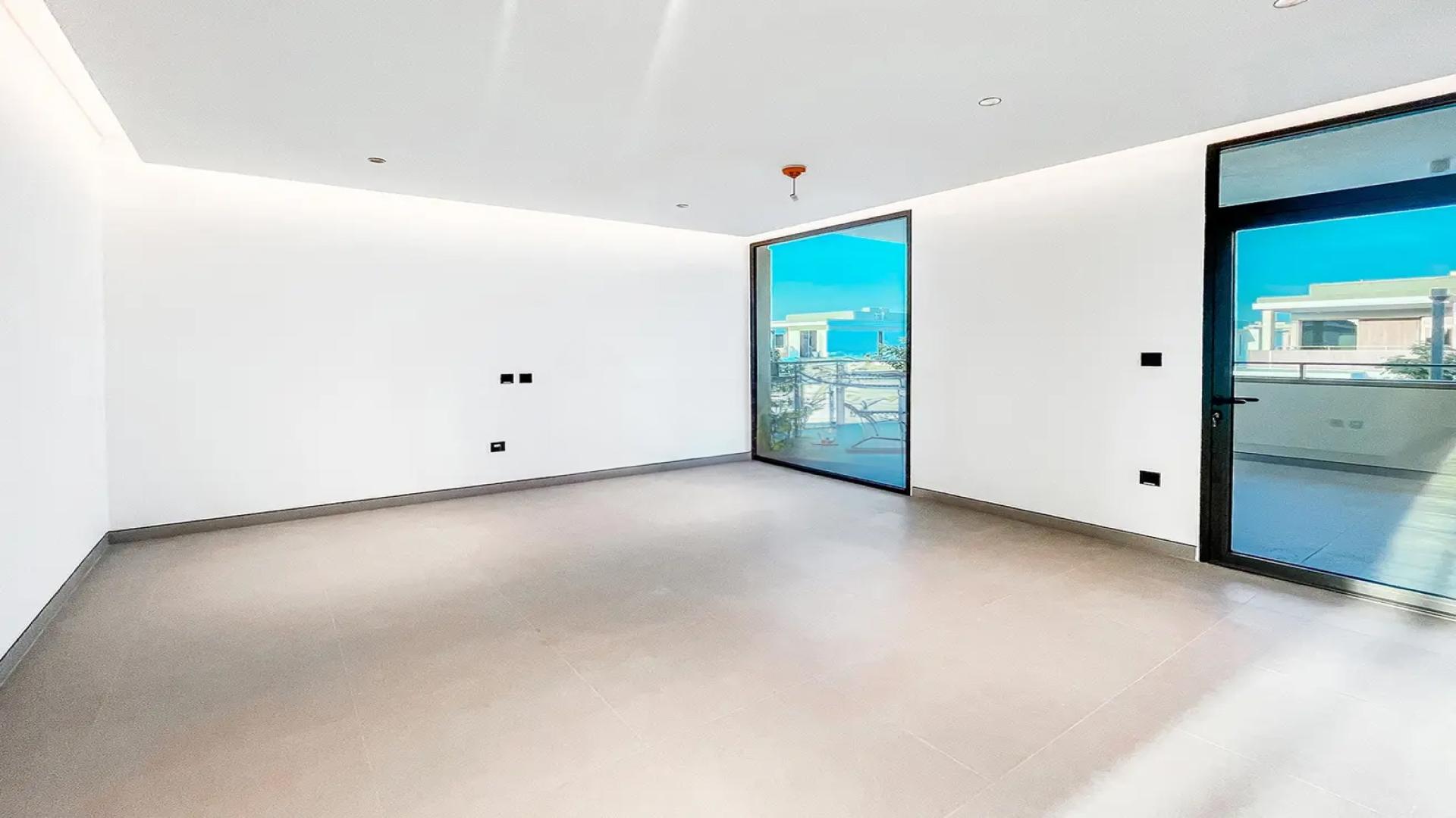 "Modern 4-bedroom villa with pool in Harmony 1, Tilal Al Ghaf, for rent.",Spacious empty room with large window in Tilal Al Ghaf villa for rent