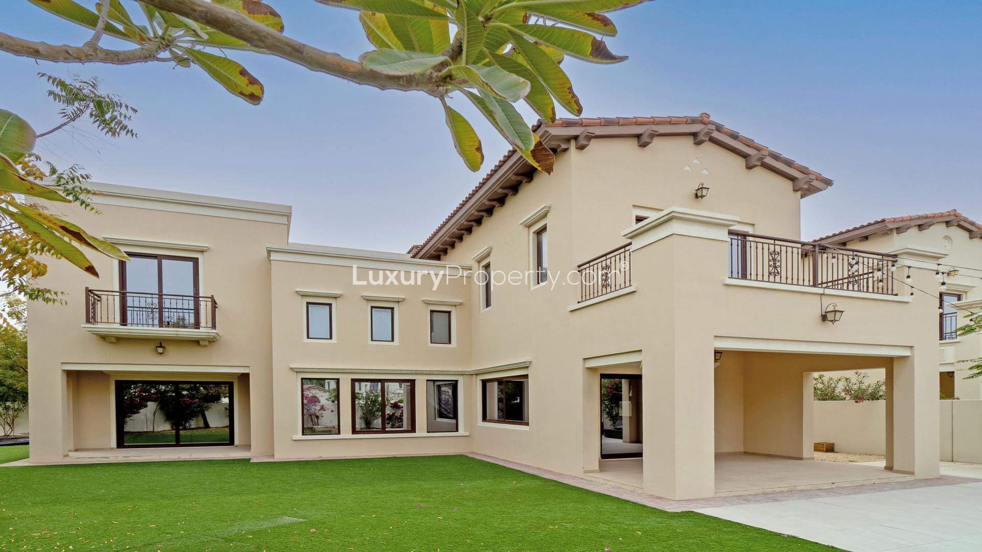 "Spacious living room in Rosa Villa, Arabian Ranches 2, with large windows and tiled floor.","Spacious 4-bedroom Rosa Villa for rent in Arabian Ranches 2, large plot, prime location.",Vacant living area in Rosa Villa, Arabian Ranches 2, with large windows and garden view