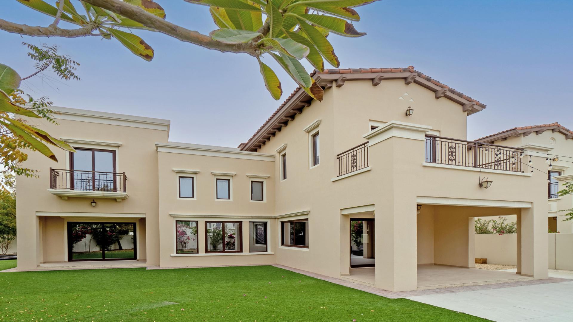 "Spacious living room in Rosa Villa, Arabian Ranches 2, with large windows and tiled floor.","Spacious 4-bedroom Rosa Villa for rent in Arabian Ranches 2, large plot, prime location.",Vacant living area in Rosa Villa, Arabian Ranches 2, with large windows and garden view