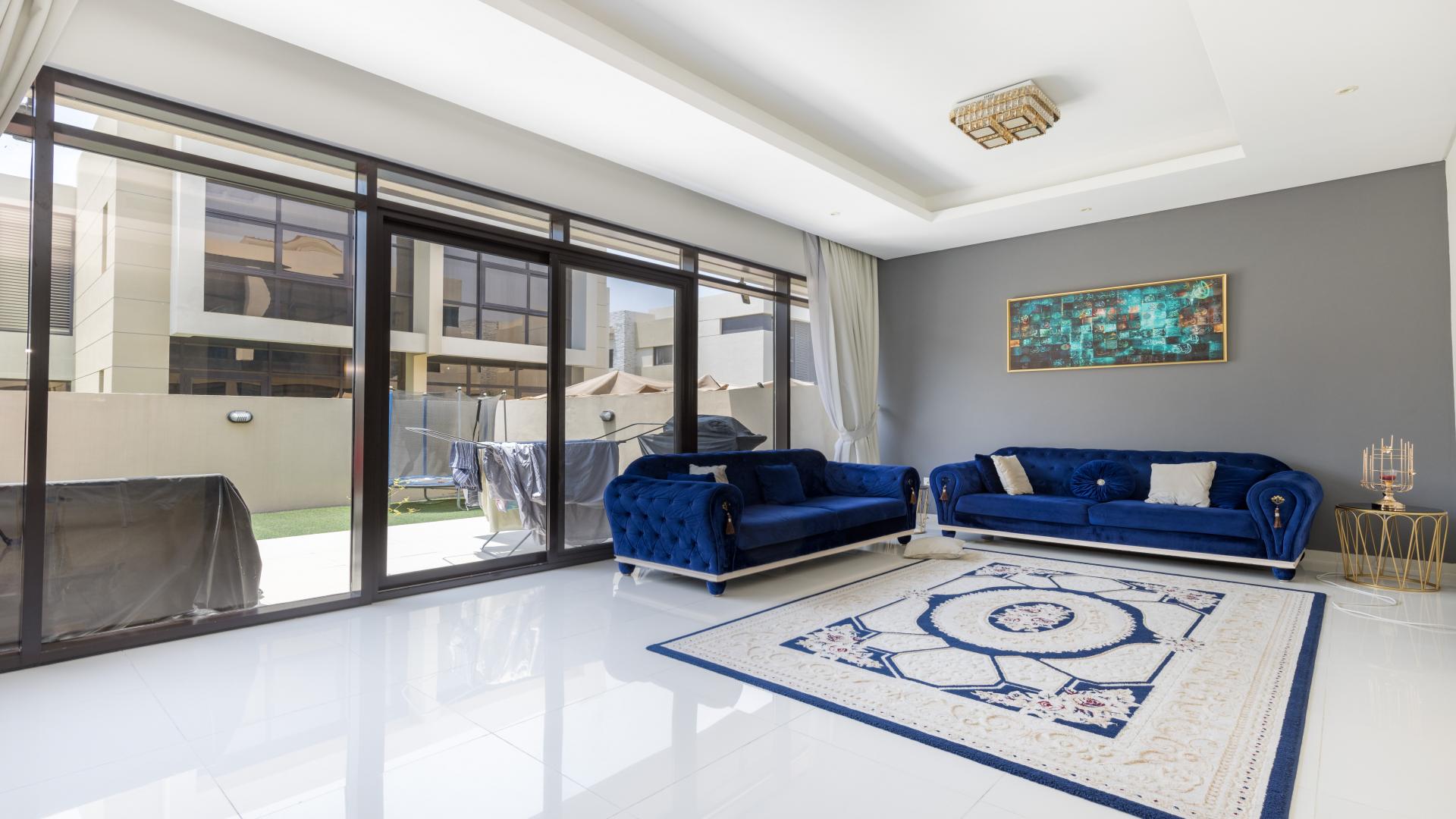 Modern villa exterior with carport in Damac Hills, Rochester community, available for rent