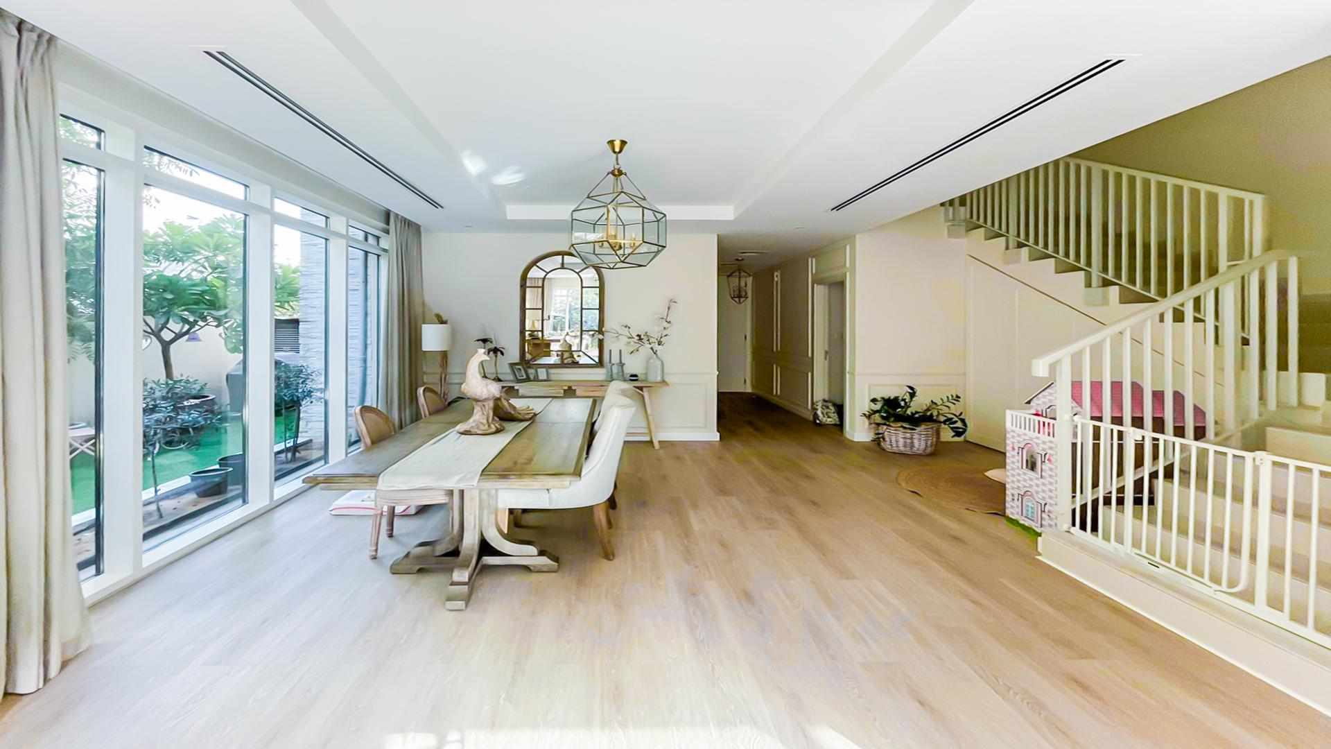 Bright, spacious living room in upgraded Damac Hills villa with garden view and modern decor