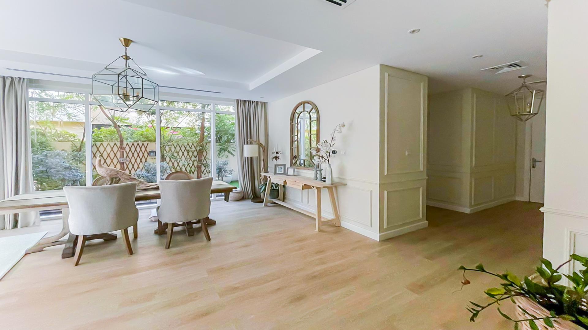 Bright living room with garden view in Damac Hills villa, The Field community