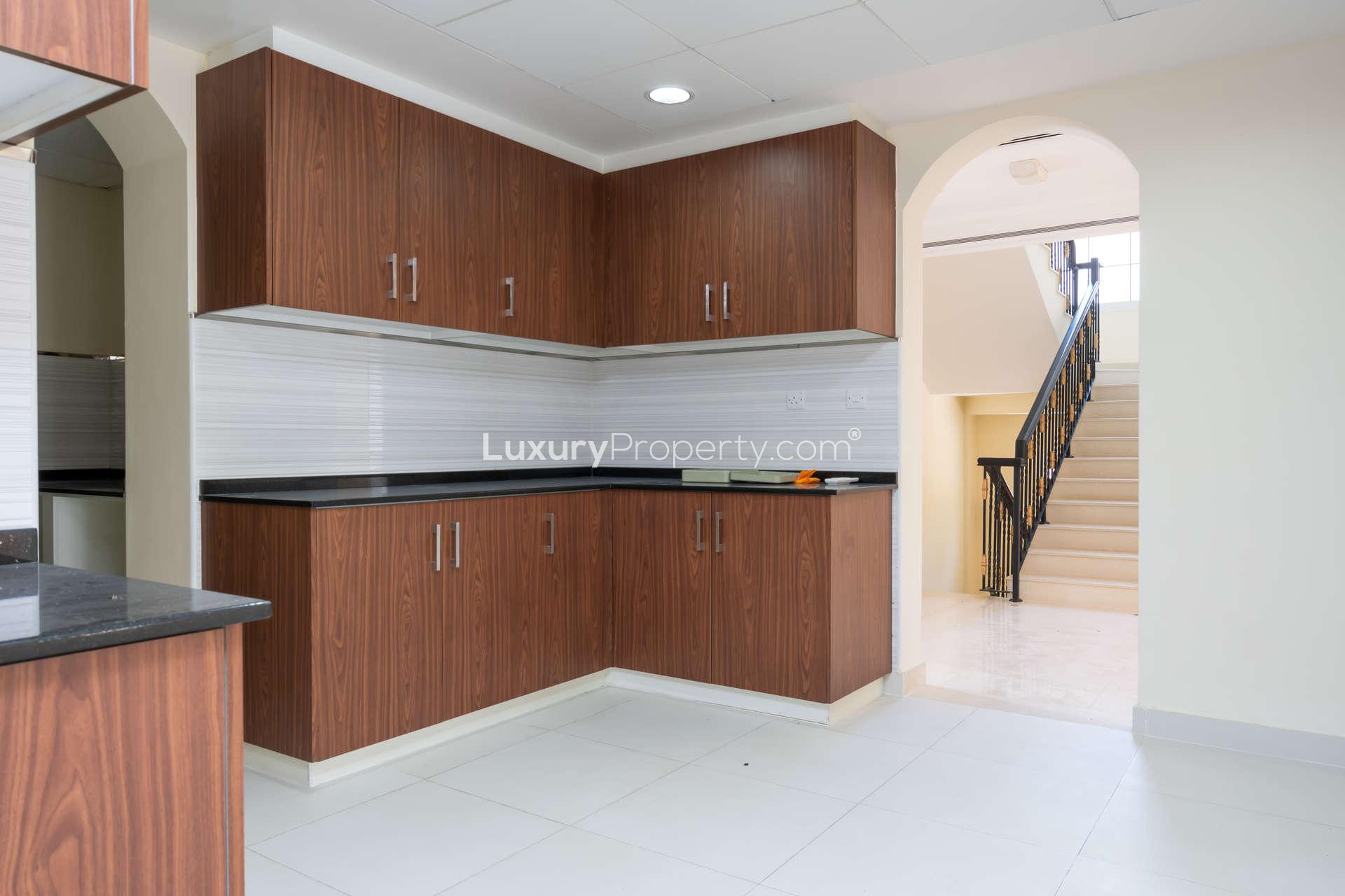 Modern kitchen in 4-bedroom Il Vento Villa, Jumeirah Golf Estates, featuring sleek cabinetry