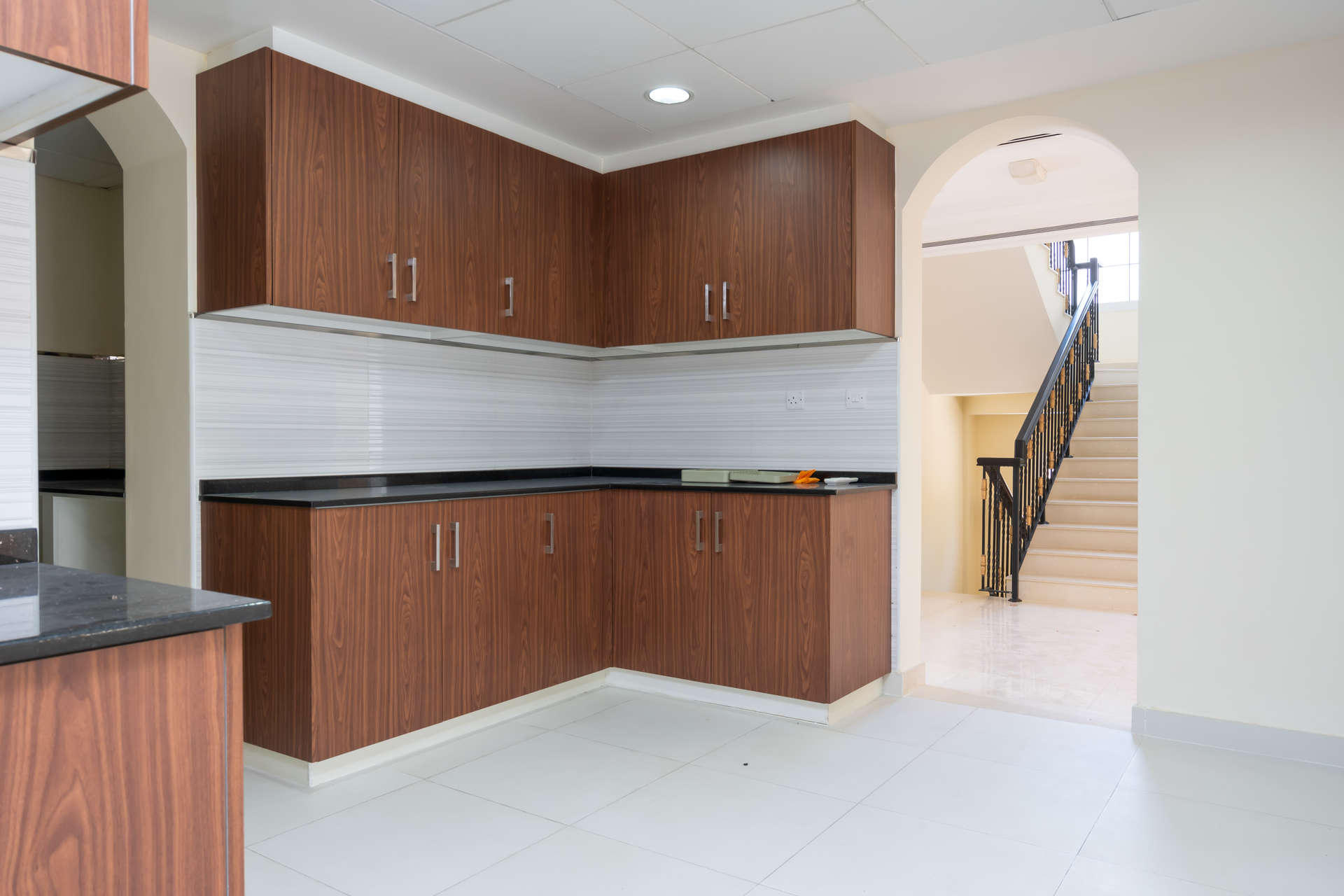 Modern kitchen in 4-bedroom Il Vento Villa, Jumeirah Golf Estates, featuring sleek cabinetry