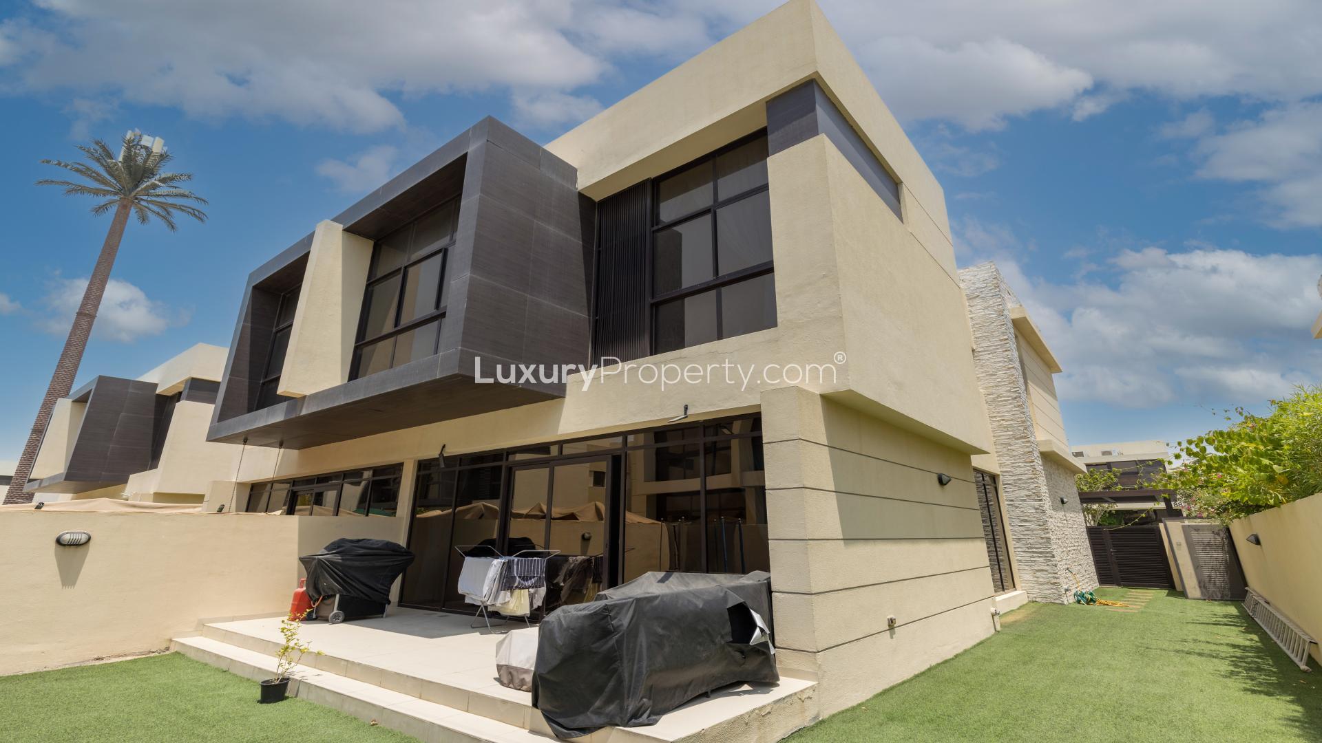 Luxurious living room in 4-bedroom villa, The Turf, Damac Hills with elegant blue sofas
