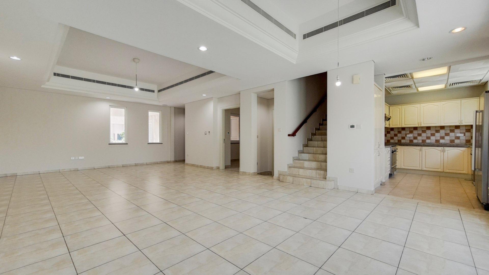 Spacious living room with large windows in Victory Heights villa, Dubai Sports City