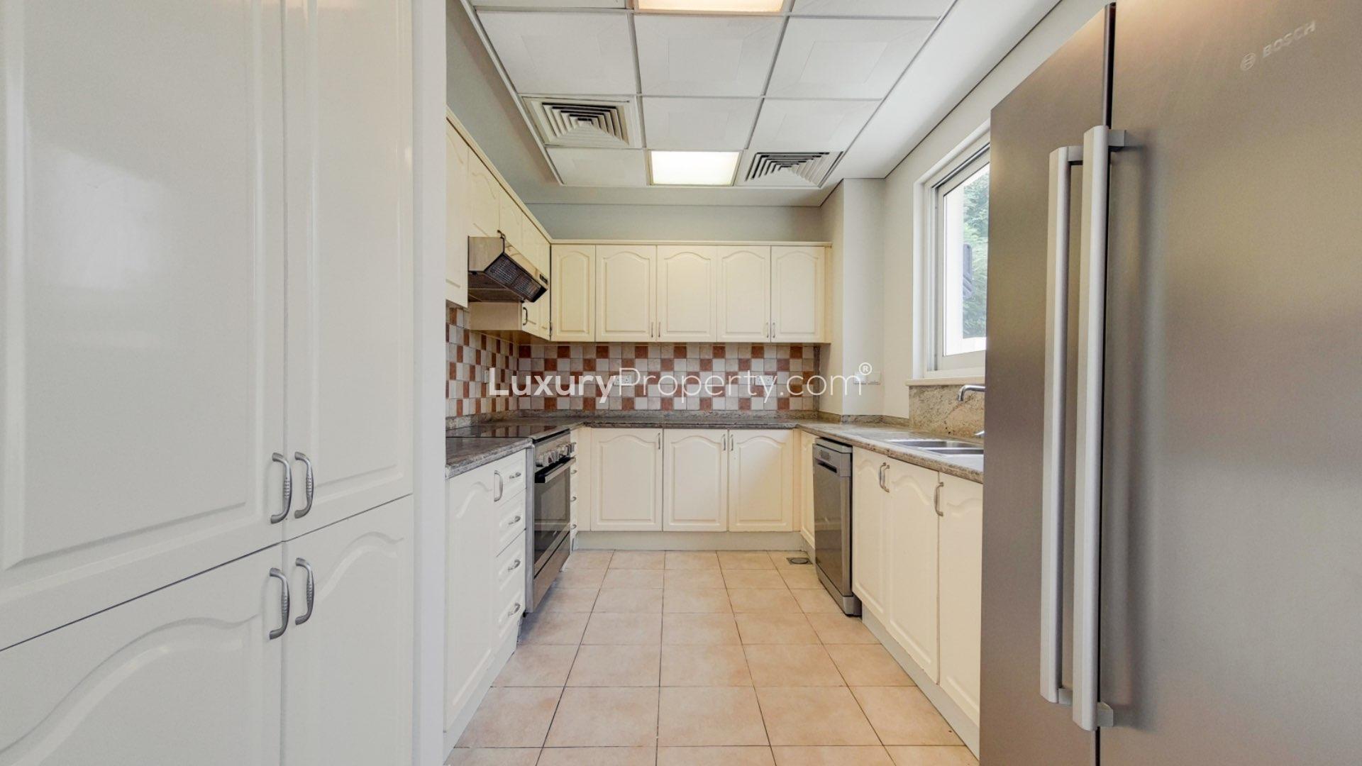 Spacious villa interior with tiled floors and kitchen in Victory Heights, Dubai Sports City