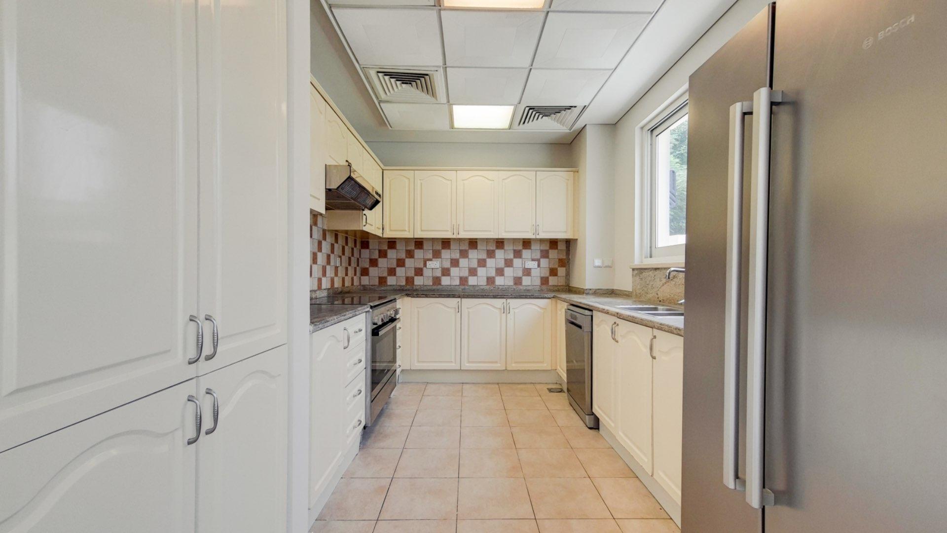 Spacious villa interior with tiled floors and kitchen in Victory Heights, Dubai Sports City