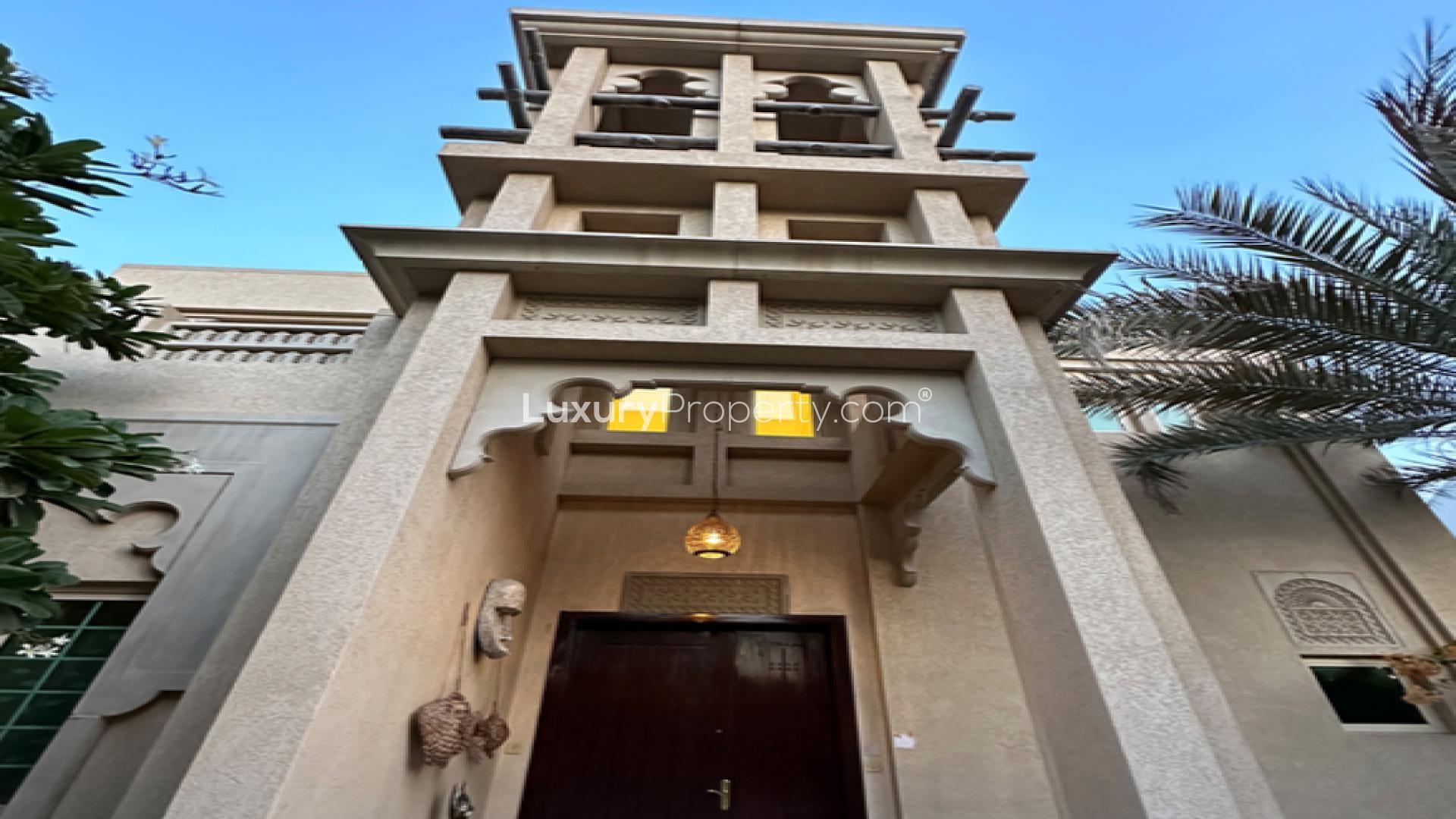Luxurious living room in Jumeirah Islands villa, featuring elegant decor and high ceiling