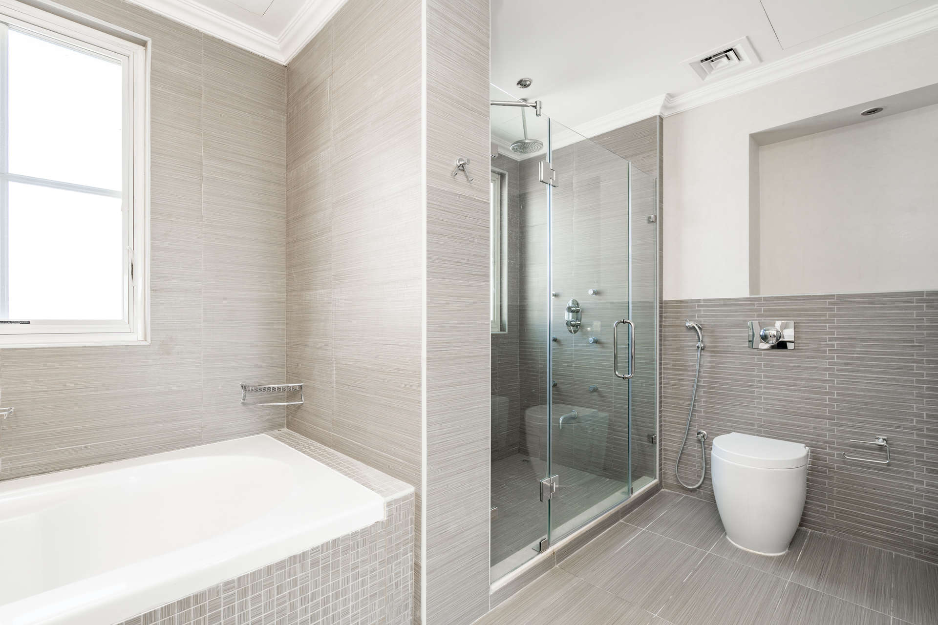 Modern bathroom with dual sinks and bathtub in Jumeirah Golf Estates villa for rent