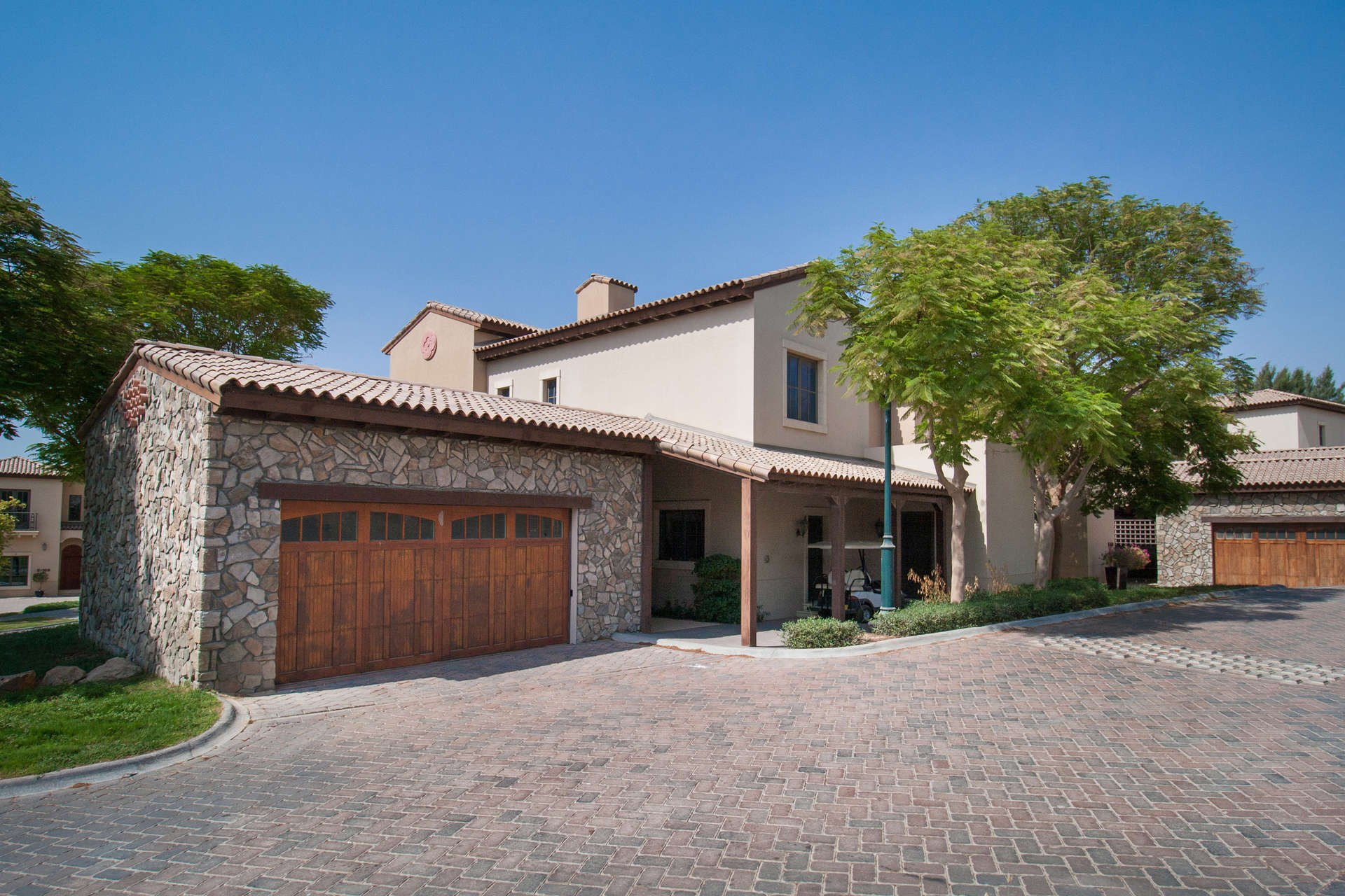 Gorgeous 4-bedroom villa exterior in Whispering Pines, Jumeirah Golf Estates, with stone facade