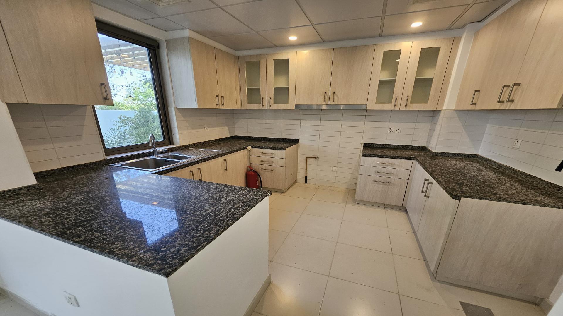 Lush garden view of 4-bed villa patio at Mira Oasis, Reem community