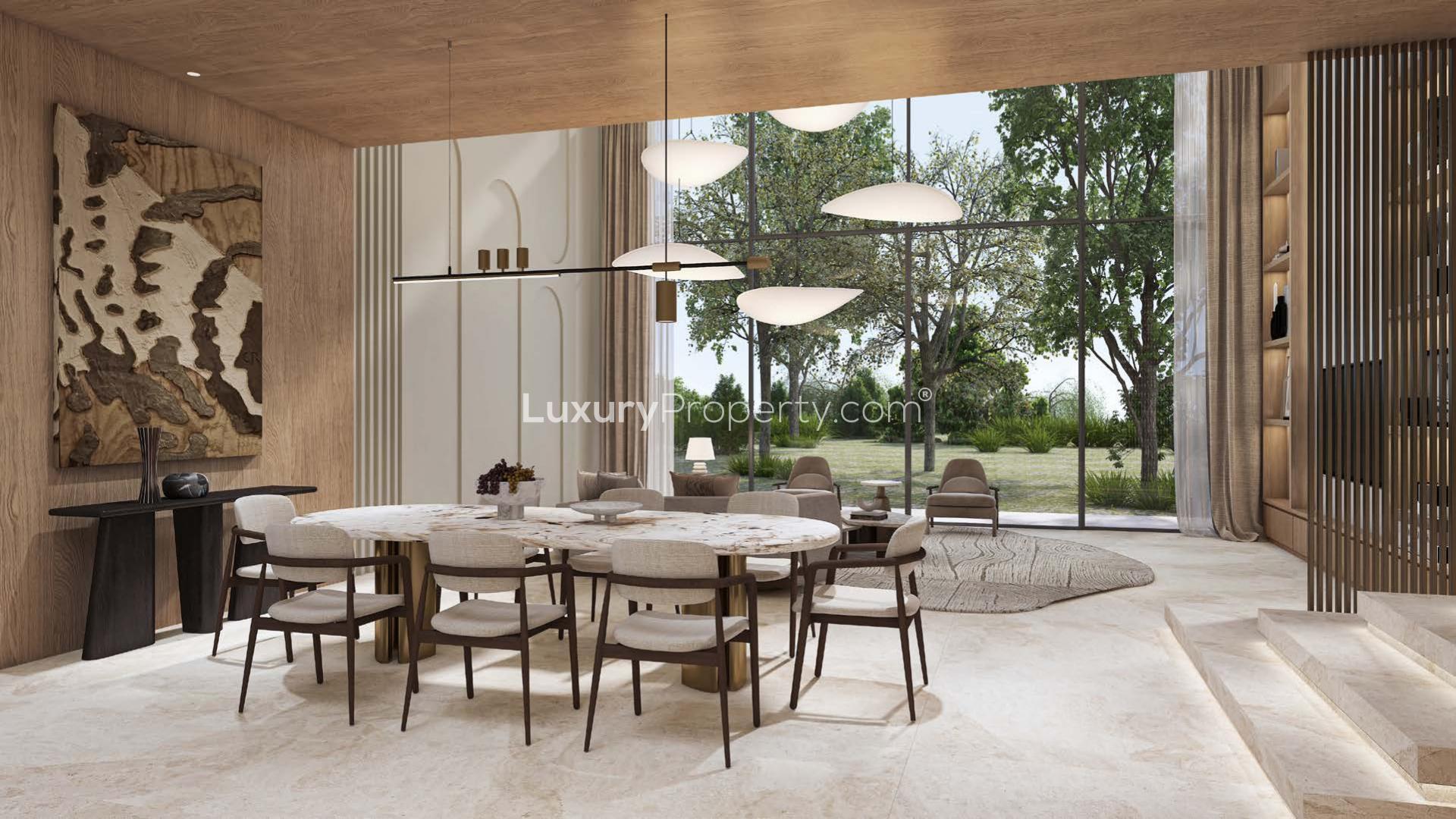 French-inspired villa exterior in Tilal Al Ghaf community, lush landscaping, modern architecture