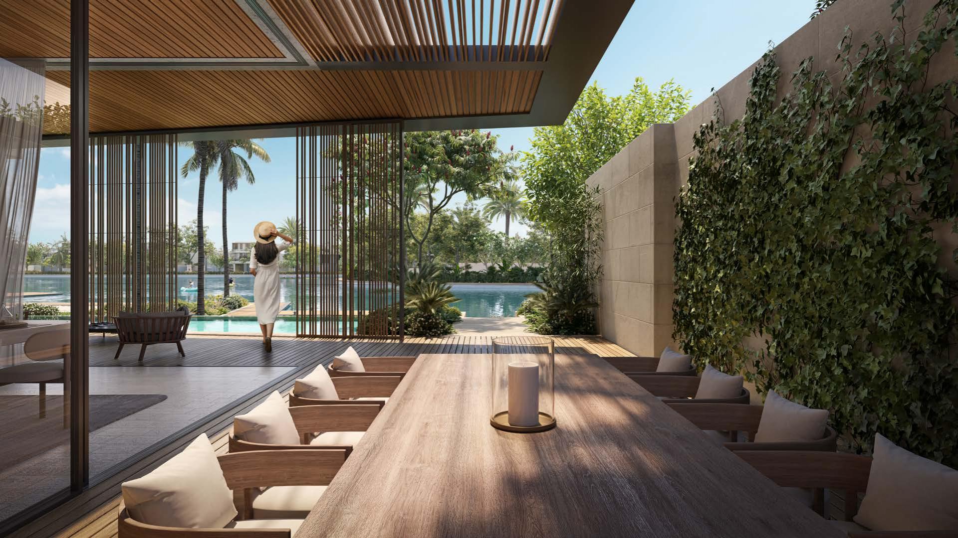 Luxury villa interior with open terrace and pool view in Tilal Al Ghaf