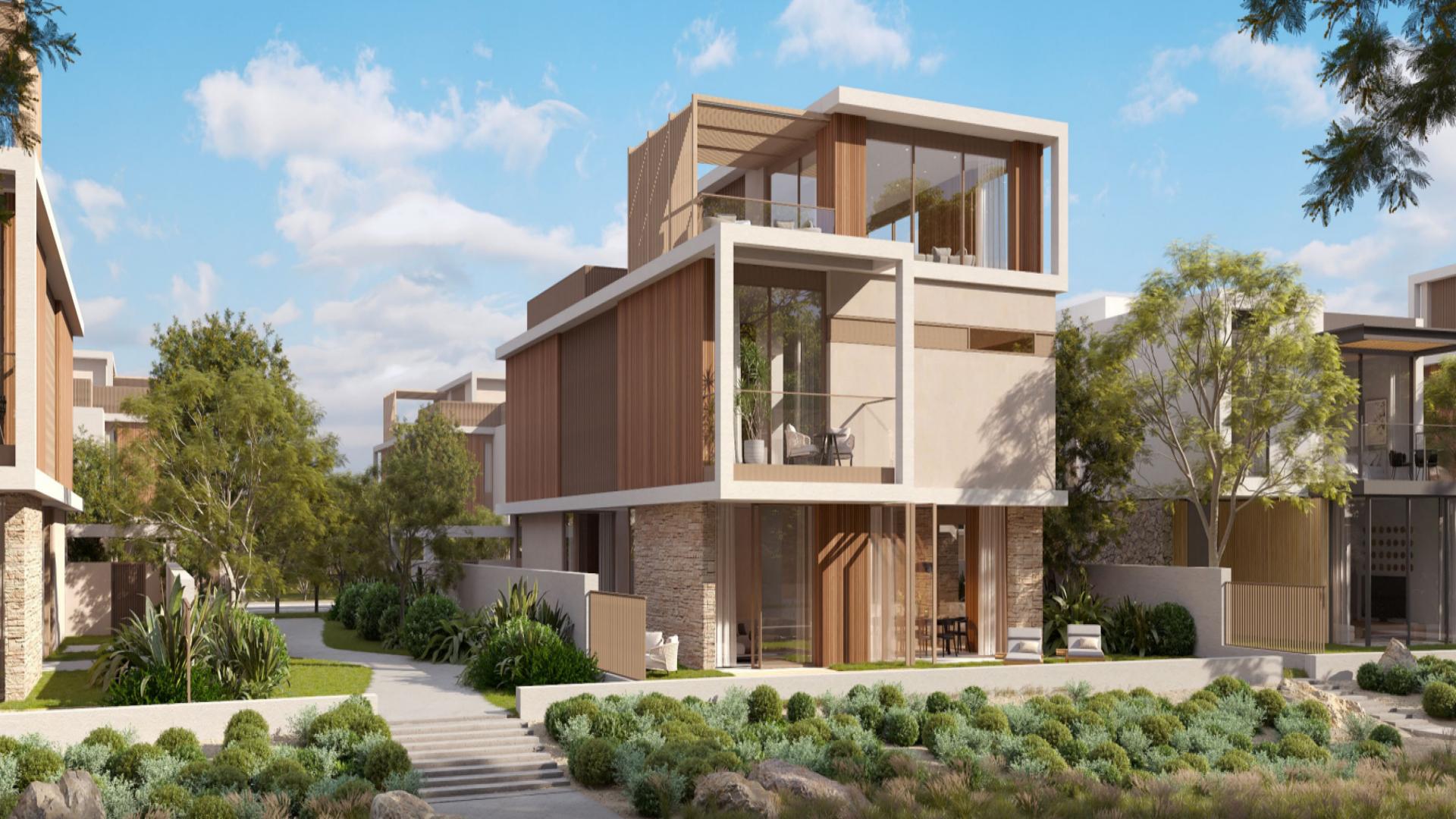 Modern open-plan villa interior with stone wall and floating staircase in The Acres, Dubai Land