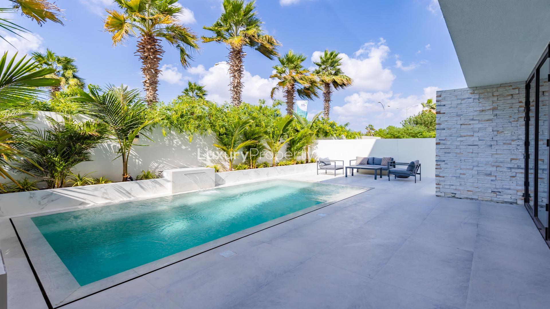 Luxurious living room with pool view in 4-bed villa, Damac Hills, Brookfield