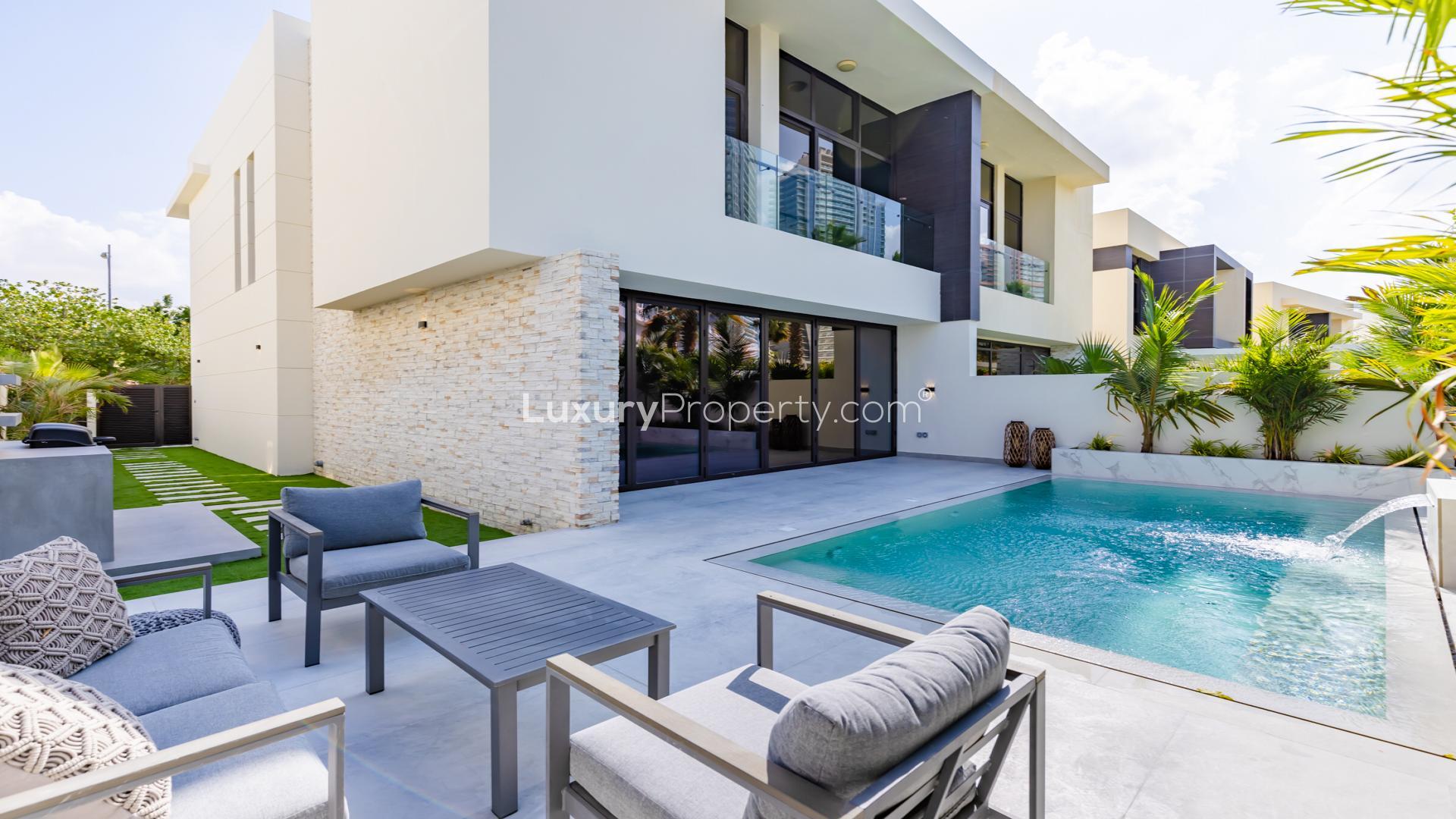Luxurious villa pool and patio in Damac Hills' Brookfield community, ideal for relaxation
