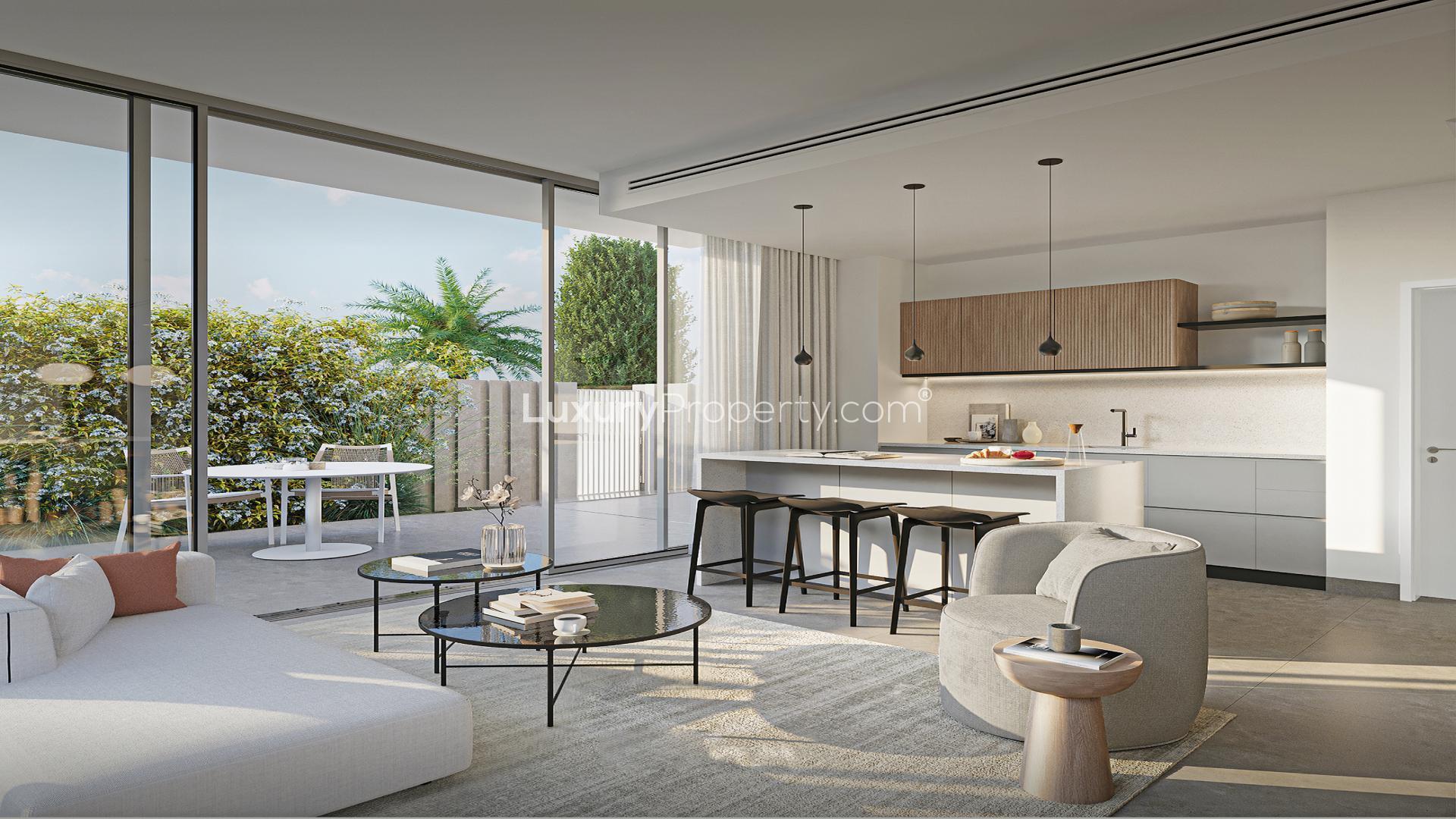 "Modern 4-bedroom twin villa exterior in Arabian Ranches 3, June community, for sale.",Modern open-plan kitchen and living room in Arabian Ranches 3 twin villa, June community