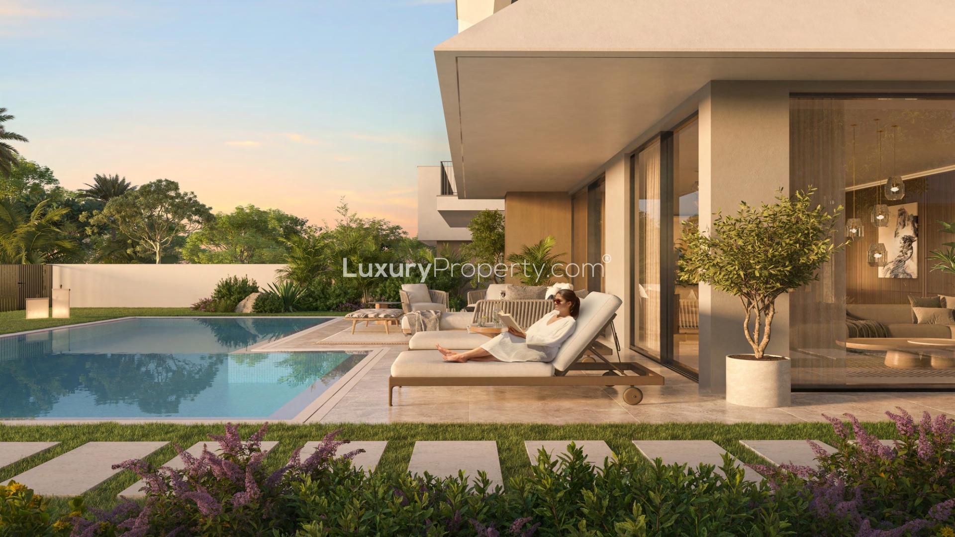 Elegant villa with pool in Emaar South’s Golf Lane, surrounded by lush greenery