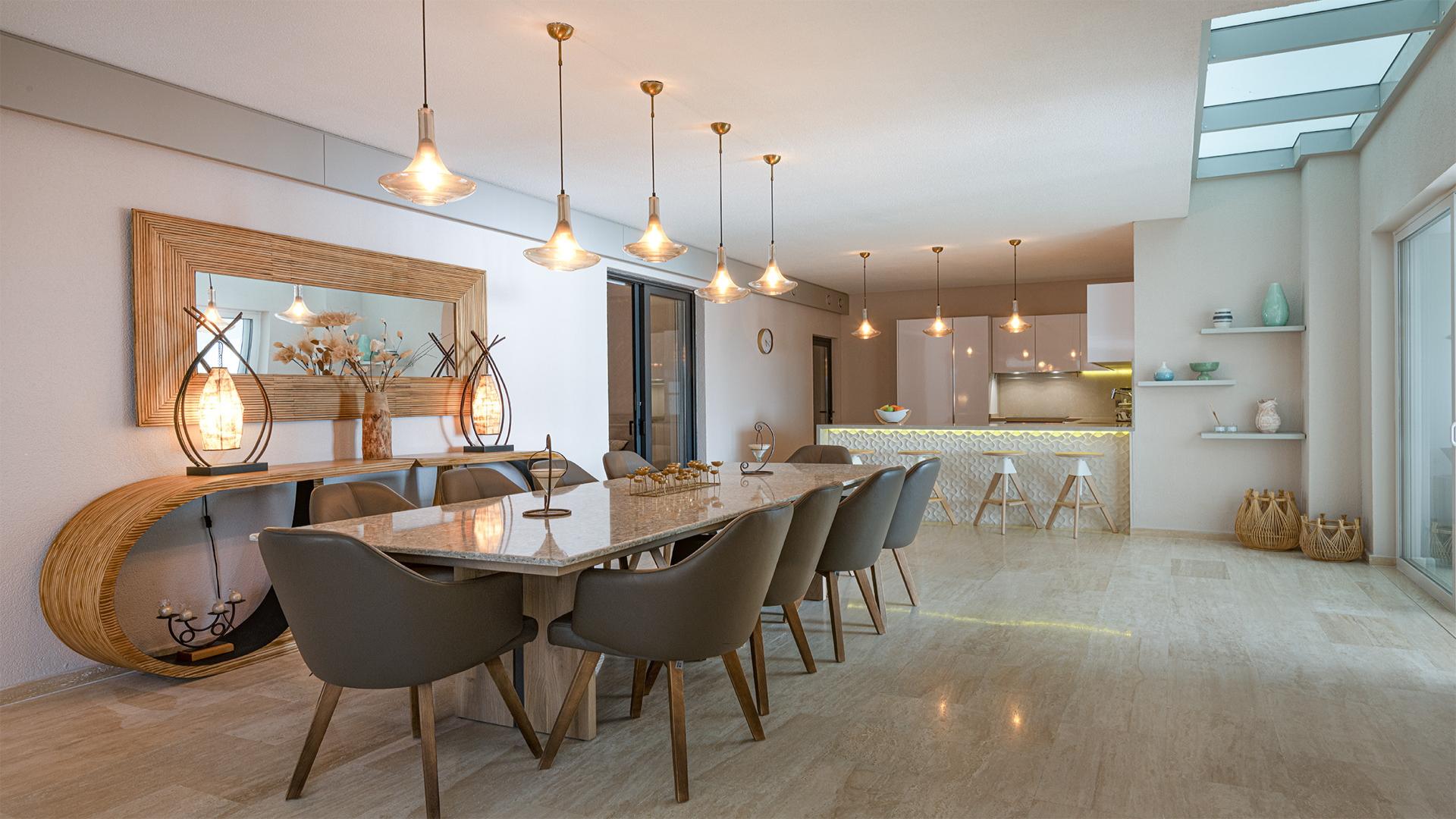 Modern kitchen and dining area in Bodrum villa, Pera Gümüşlük Evleri, with elegant lighting