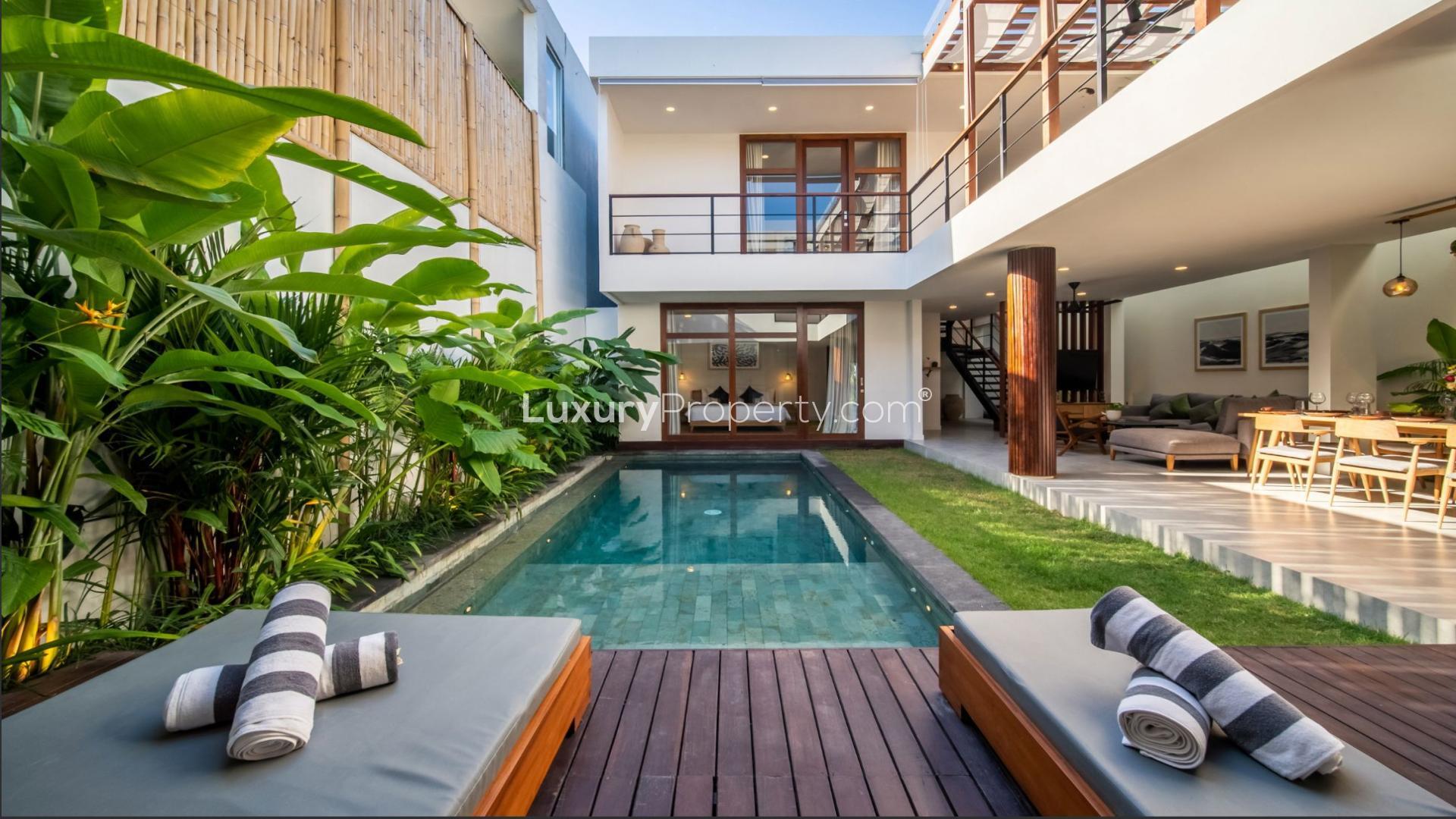 Dining area overlooking pool in luxury villa for sale, Berawa, Bali