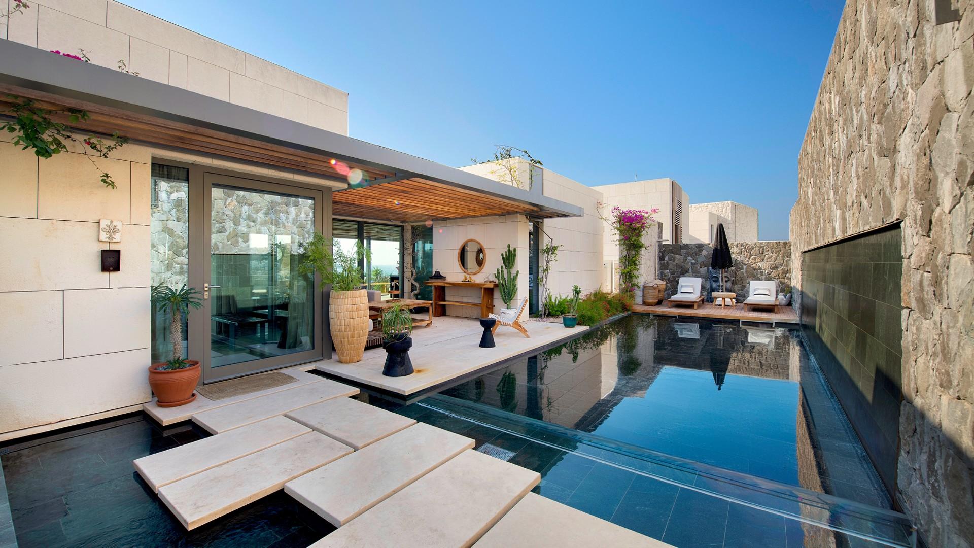 Two-storey villa exterior, lush greenery, Ritz-Carlton Bodrum, for sale, luxury residential property