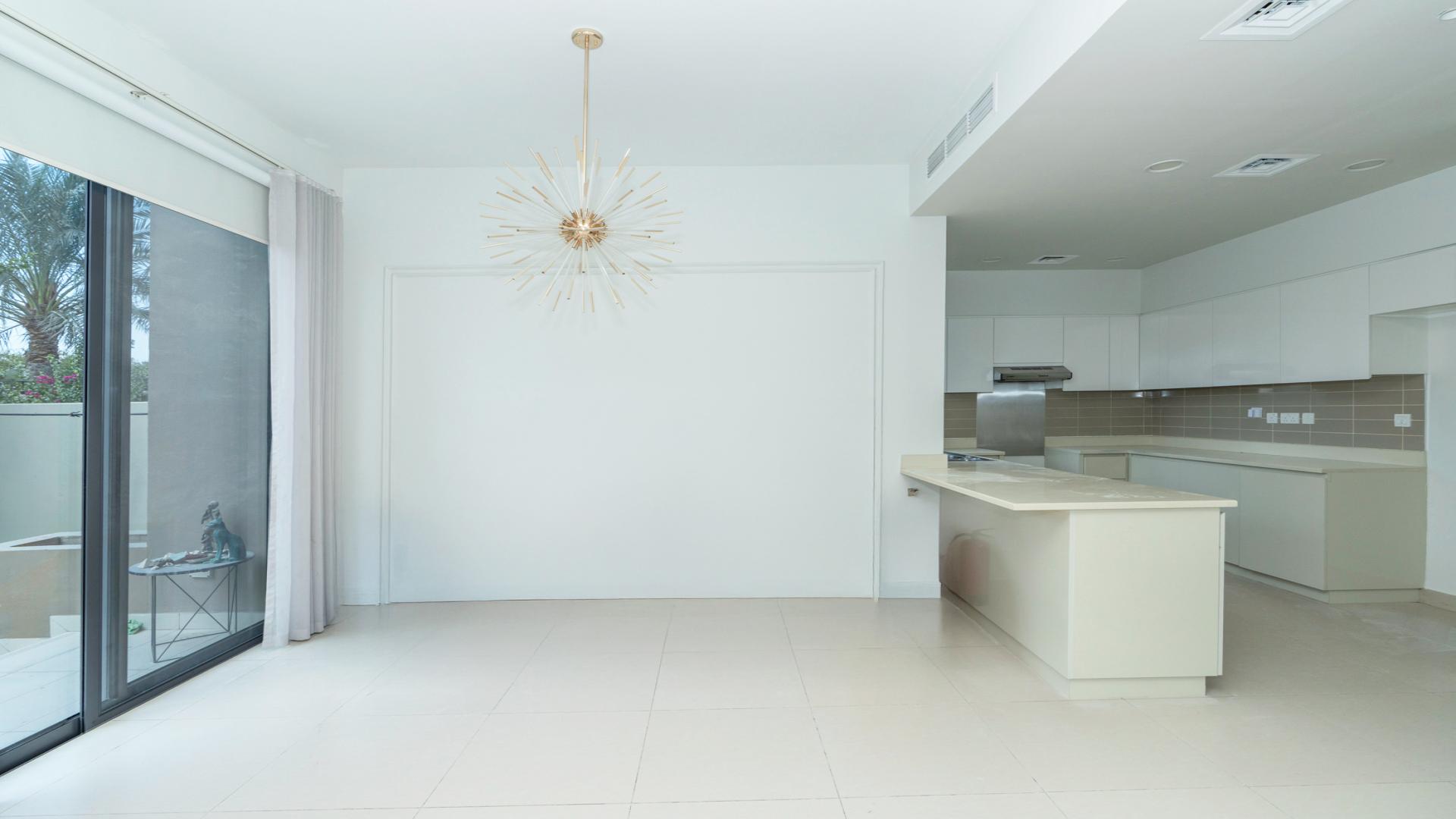 "Spacious kitchen and dining area in Dubai Hills Estate villa, Maple community, Type 2E.",Bright living room in vacant 4-bedroom villa, Dubai Hills Estate, Maple community, large windows